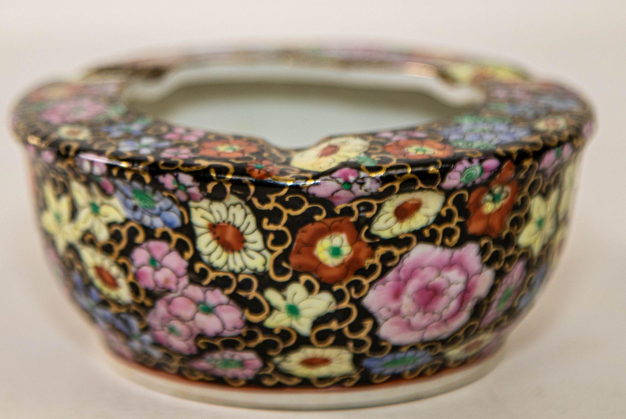 Vintage Asian porcelain hand painted floral ashtray hand made in China.
This gorgeous gilded ashtray is intricately hand-painted with Asian floral lotus decoration in gilt and geometric design on black background in blue red green and gold jeweled