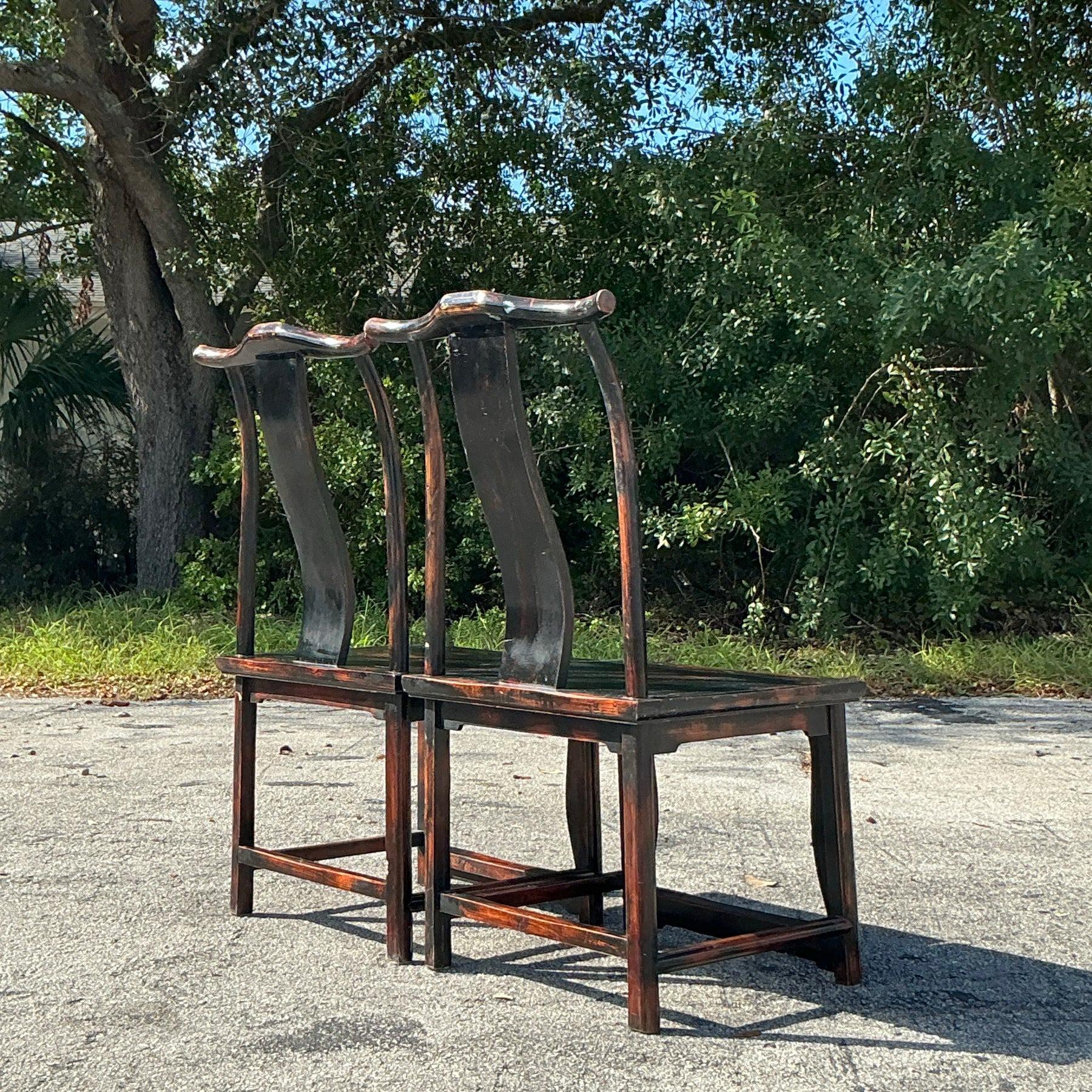 A stunning pair of Vintage Asian Emperor Chairs crafted from reclaimed wood, featuring intricate carvings and a rich patina that tells a story of heritage and artistry. These unique chairs blend traditional design with timeless elegance, making them