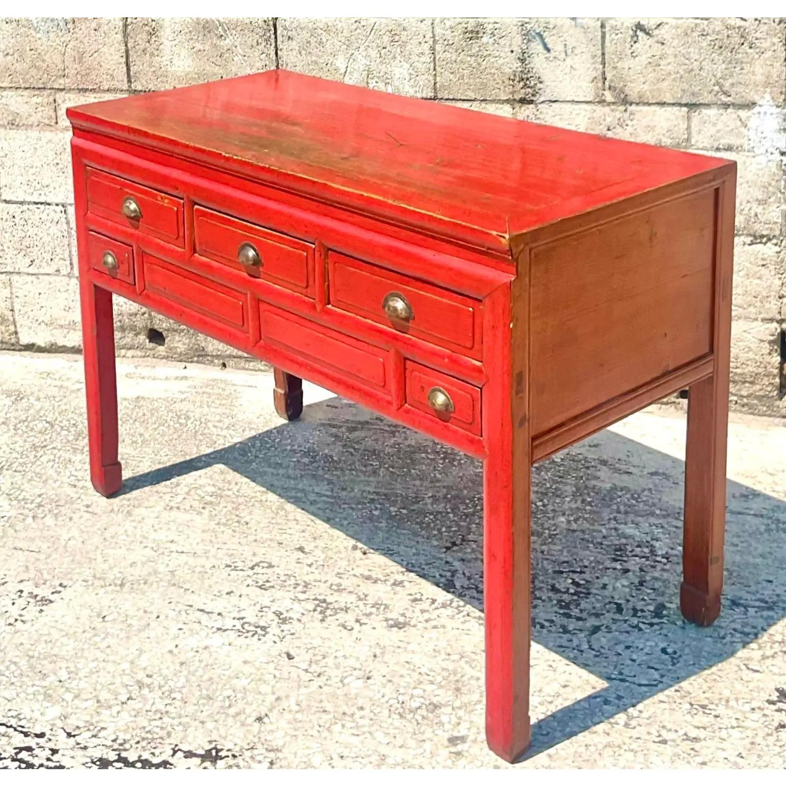 Fantastic vintage Asian sideboard. Beautiful glossy lipstick red distressed finish. Made from a solid reclaimed wood. A dramatic flash of color for any space. Acquired from a Palm Beach estate.