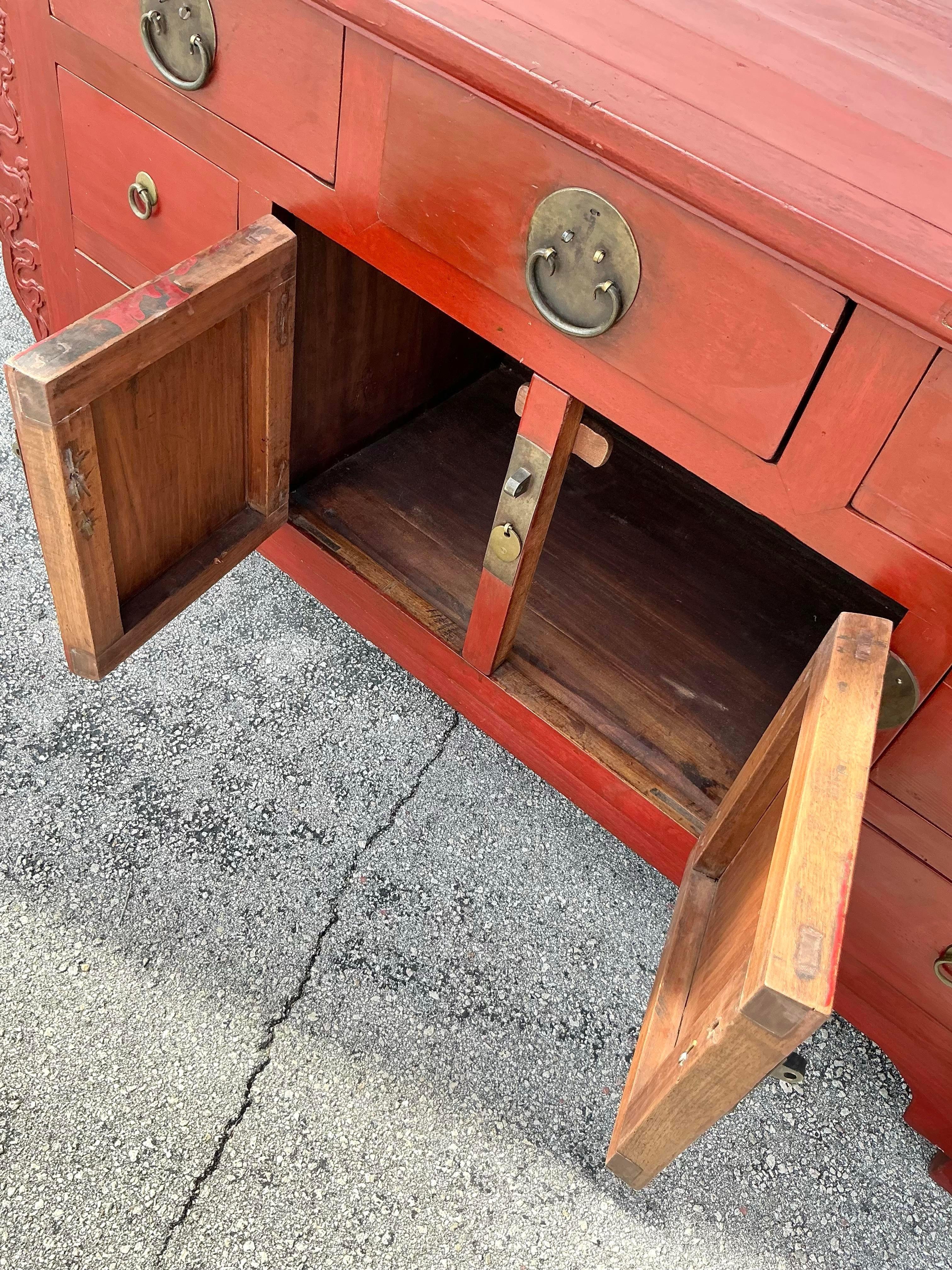 The Vintage Asian Reclaimed Wood Pagoda Credenza is a stunning example of craftsmanship inspired by traditional Asian design. Crafted from reclaimed wood, this credenza showcases a rich patina and natural grain patterns that emphasize its artisanal