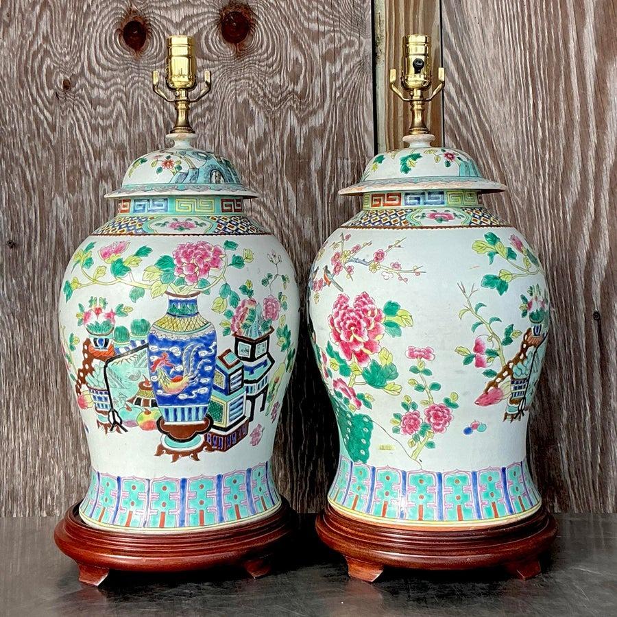 Featuring intricate hand-painted designs in the classic Rose Famille palette, these lamps showcase vibrant floral and figural motifs, rich in detail and color. The ceramic bases are complemented by ornate brass accents, creating a perfect balance of