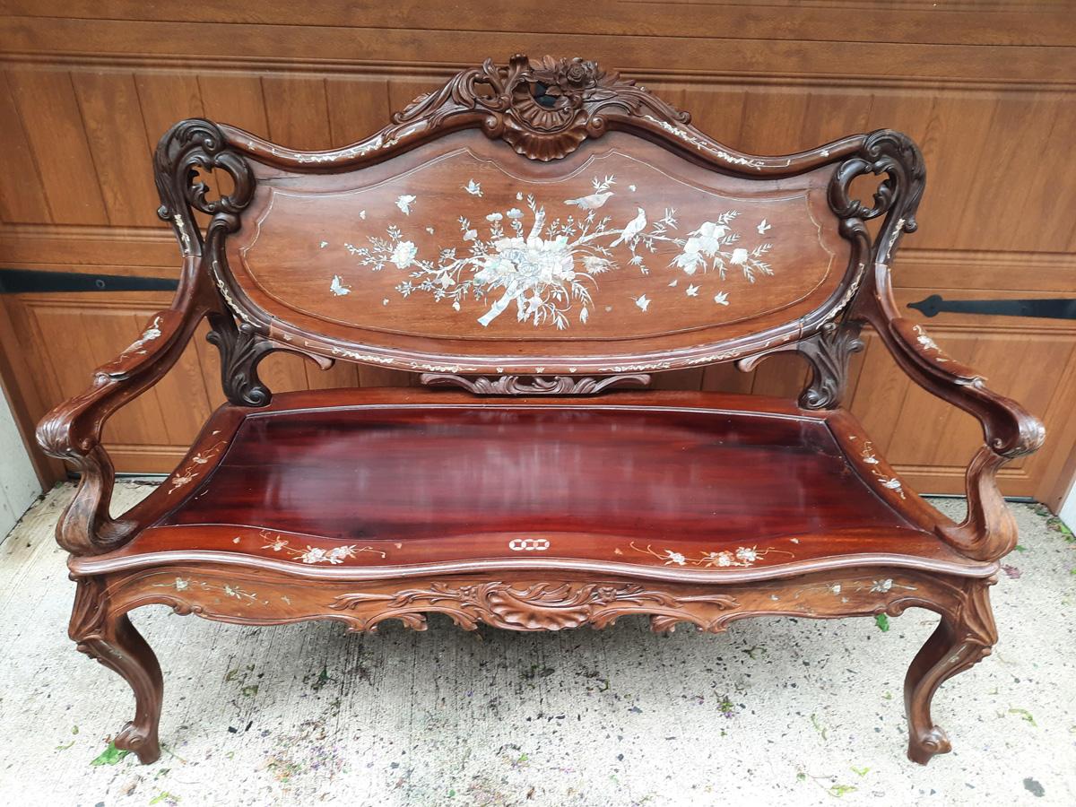 Romantic carved rosewood Asian settee with beautiful mother of pearl inlaid decoration including birds, flowers and butterflies. The cushion which was added later needs to be recovered. The back of the loveseat is also gorgeous. Arm height 27
Wood