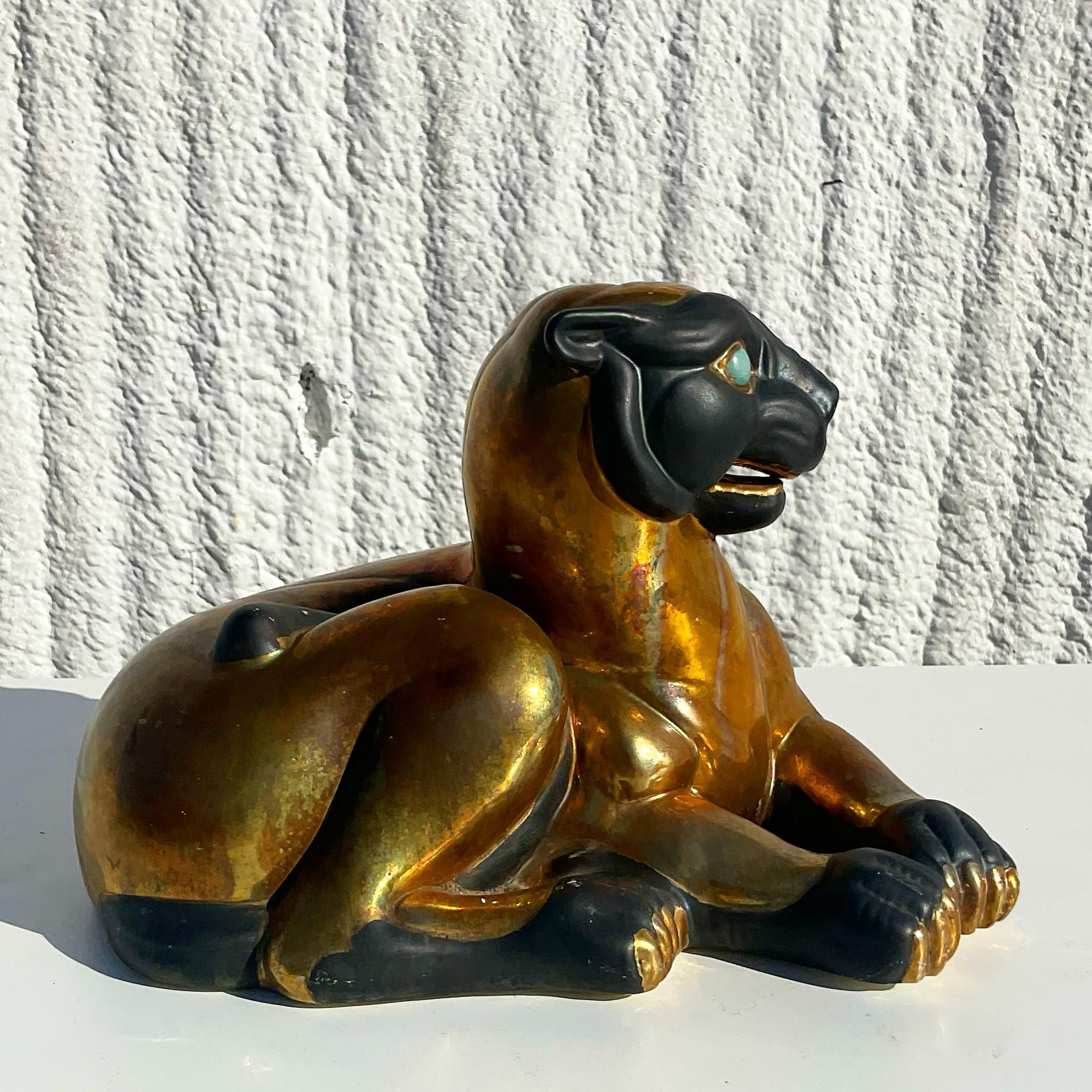 Gorgeous vintage gilt baby panther. Marked on the bottom with an Asian character. Bright and beautiful gilt finish with piercing blue stone eyes. Perfect to add a flash of glamour to any decor. Acquired from a Palm Beach estate.