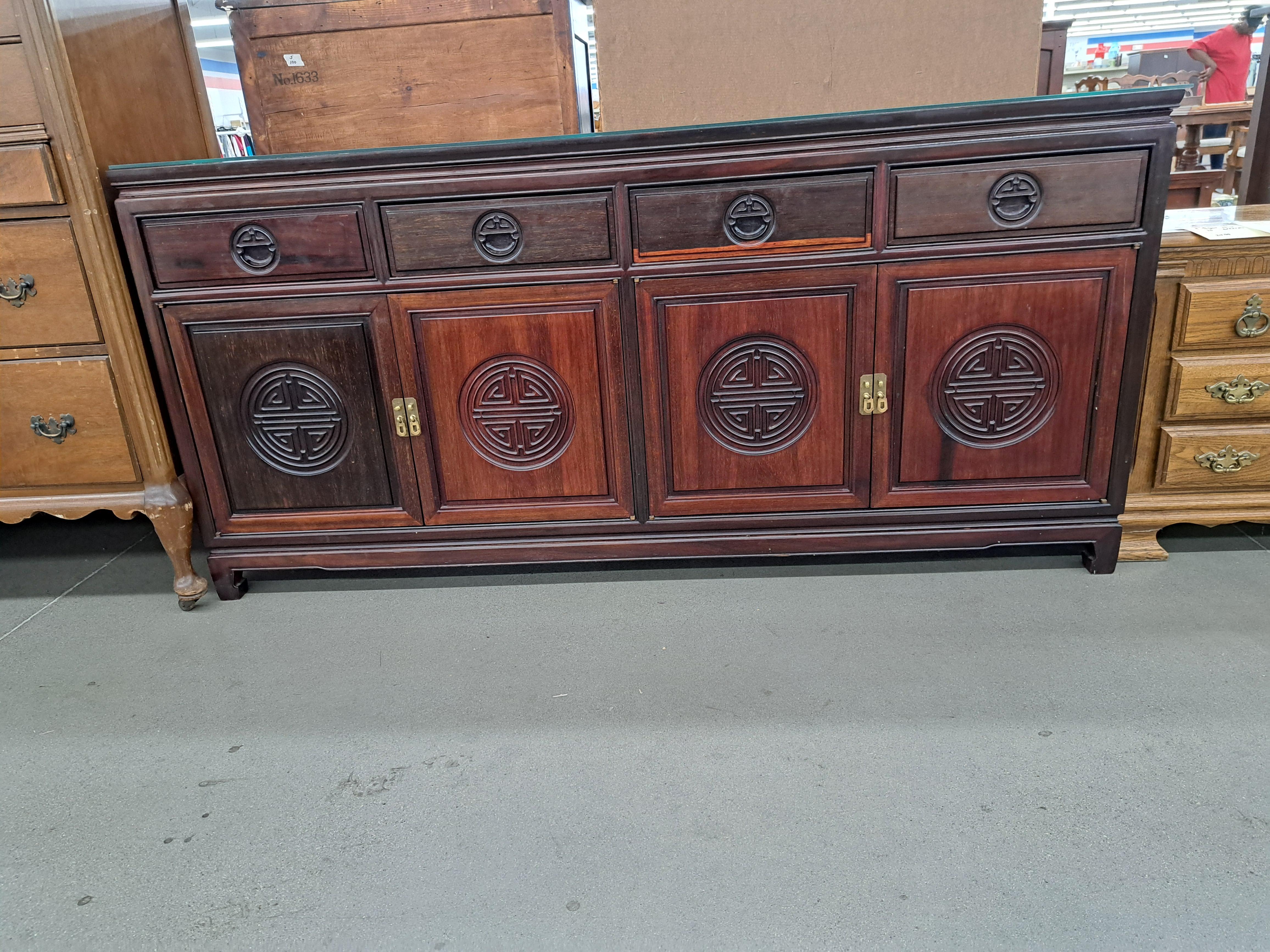 Credenza / credenza in palissandro in stile asiatico con design intagliato e vetro protettivo separato per il piano. L'unità presenta una classica falegnameria cinese e scaffali in legno coordinati. In the style of George Inness.