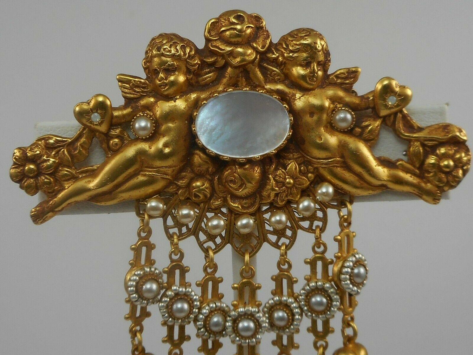 Simply Fabulous! Askew London Vintage Brooch featuring a pair of Cherubs amid Hearts and Flowers and an oval Mother of Pearl medallion, suspending seven flexible bars decorated with Hearts, enhanced with Faux Pearl Beads, edged with tiny faceted