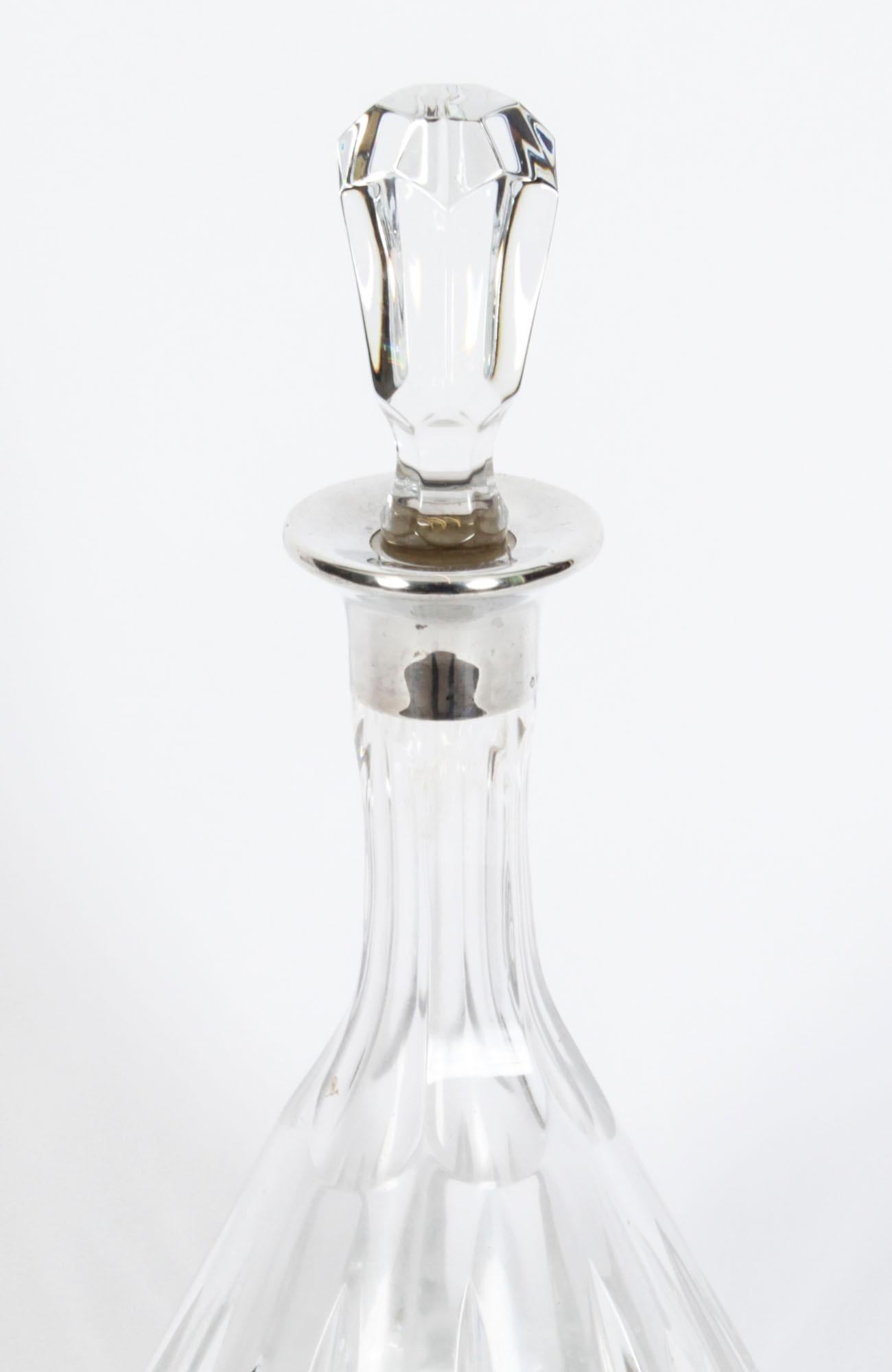 This is a lovely vintage cut glass and sterling Silver collared wine decanter by the renowned retailer Asprey, London, with date mark for 1983 and the makers mark of Asprey.

The heavy set decanter features a deep cut vertical faceted pattern with