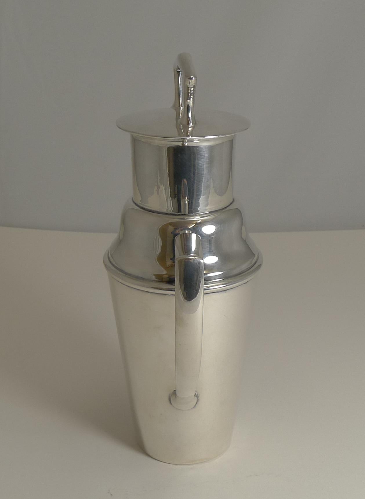 A highly sought-after cocktail Shaker by the creme de la creme of silversmiths, Asprey of London.

Made in the form of a milk churn with an Art Deco inspired take with it's angular handle and handle to remove the top.

Fully marked on the