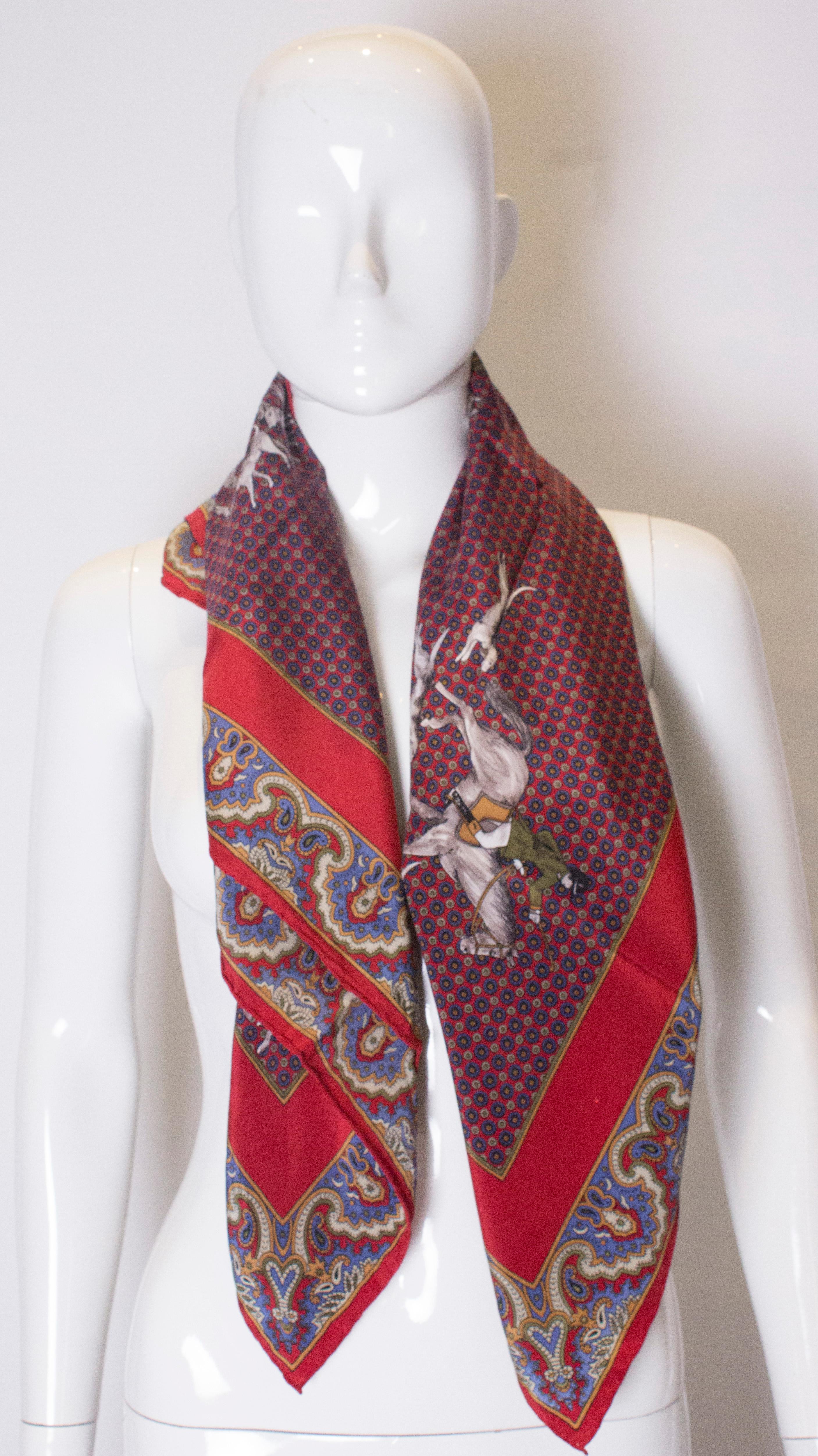 A vintage silk scarf  by royal jewelleer Asprey.  The scarf has hand rolled edges, and a horse and hounds print. It is made in Italy and measures 36'' square.