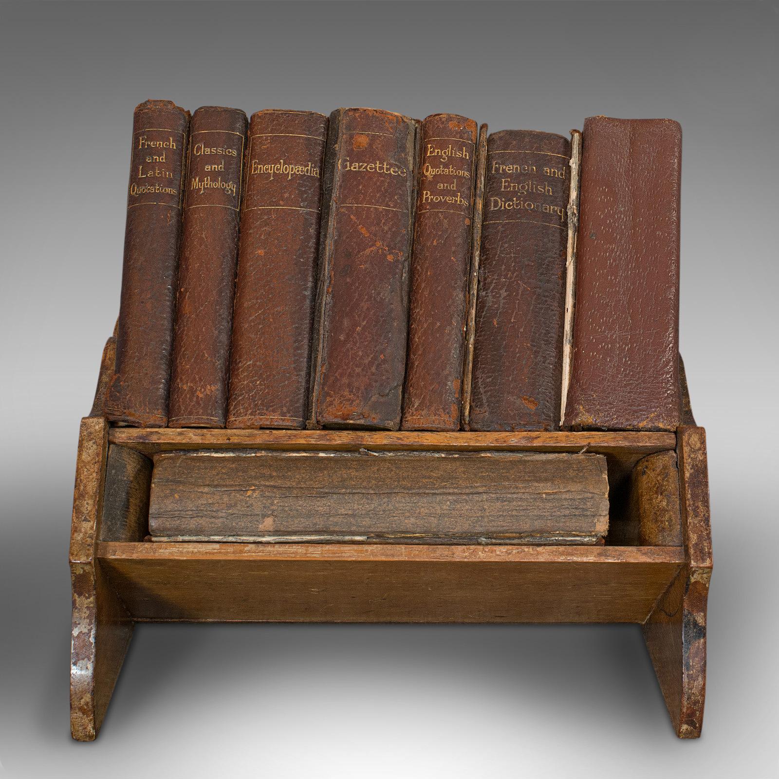 This is a vintage Asprey's of London reference library. An English, leather-bound compendium of 8 books, replete with oak display stand, dating to the early 20th century, circa 1925.

Lovingly thumbed over the last century
Displaying a timeworn,