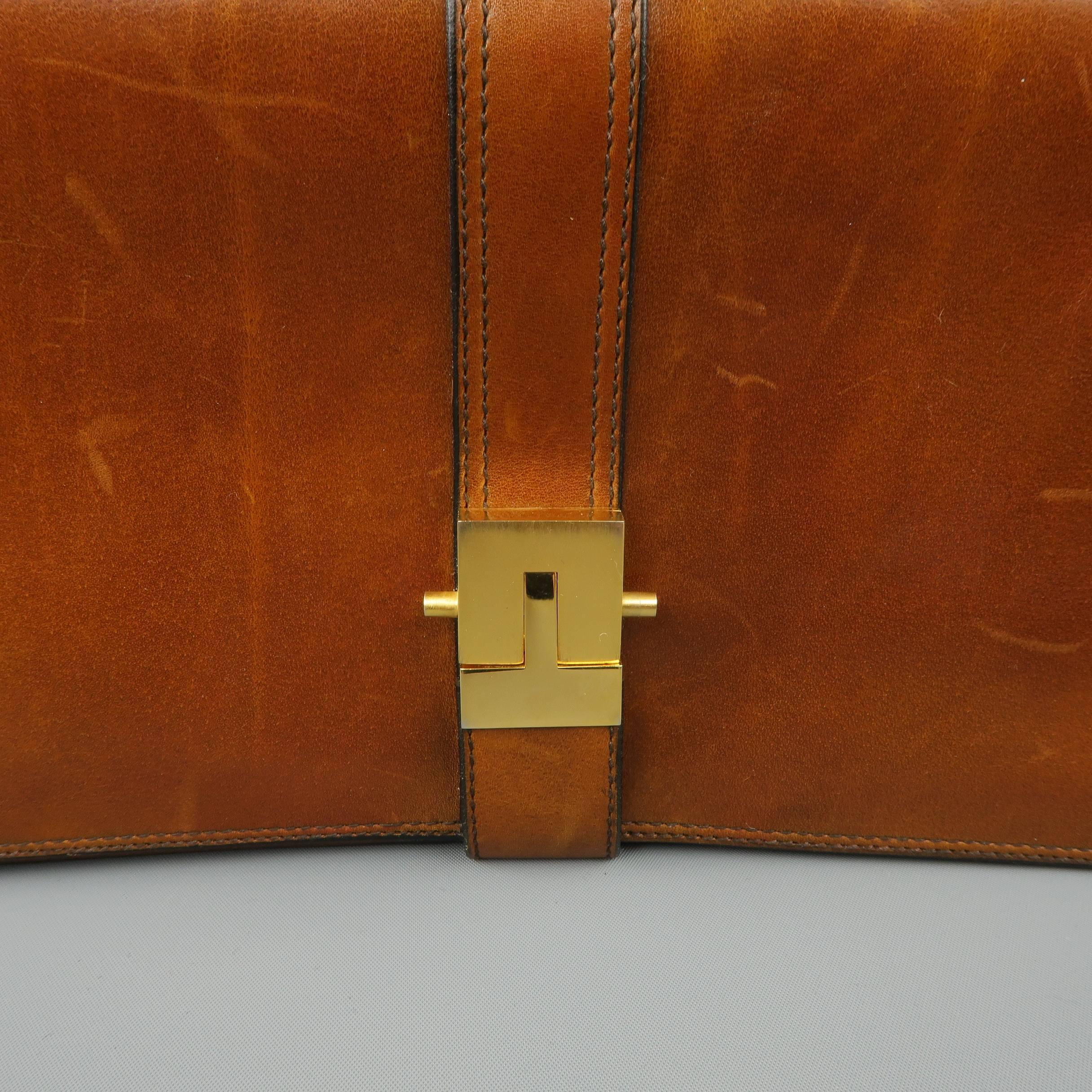 Vintage A.TESTONI for WILKES BASHFORD mini briefcase clutch comes in tan leather with a top flap, gold tone closure, internal storage compartments, and wristlet strap. Wear throughout. As-is. Made in Italy.
 
Fair Pre-Owned Condition.
