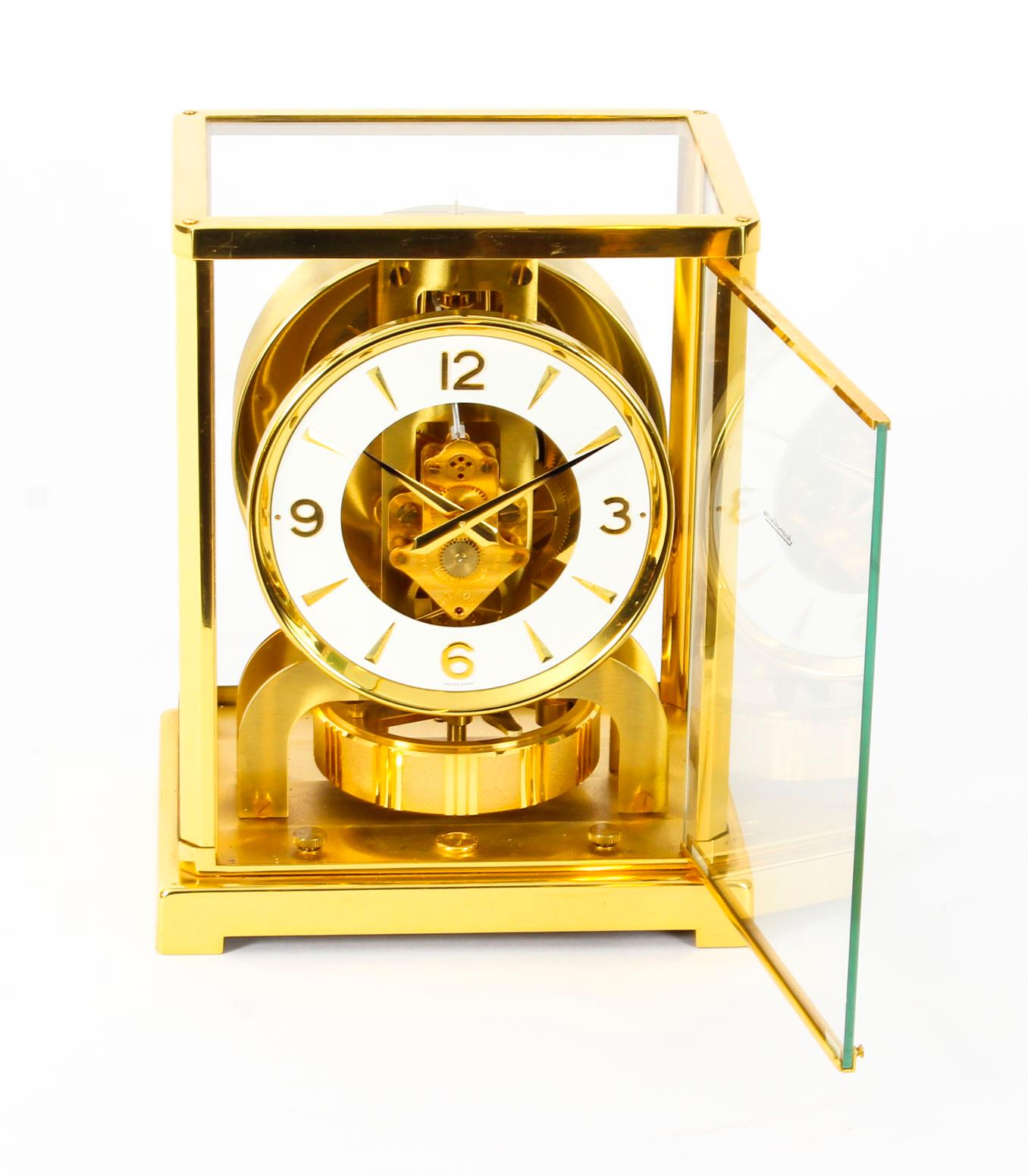 This is beautiful and very decorative vintage Atmos mantle clock by Jaeger-LeCoultre, bearing their ref No. 345158.

The clock is displayed in a polished gilt rectangular brass case with a glazed door, the case lifts off to allow access to the