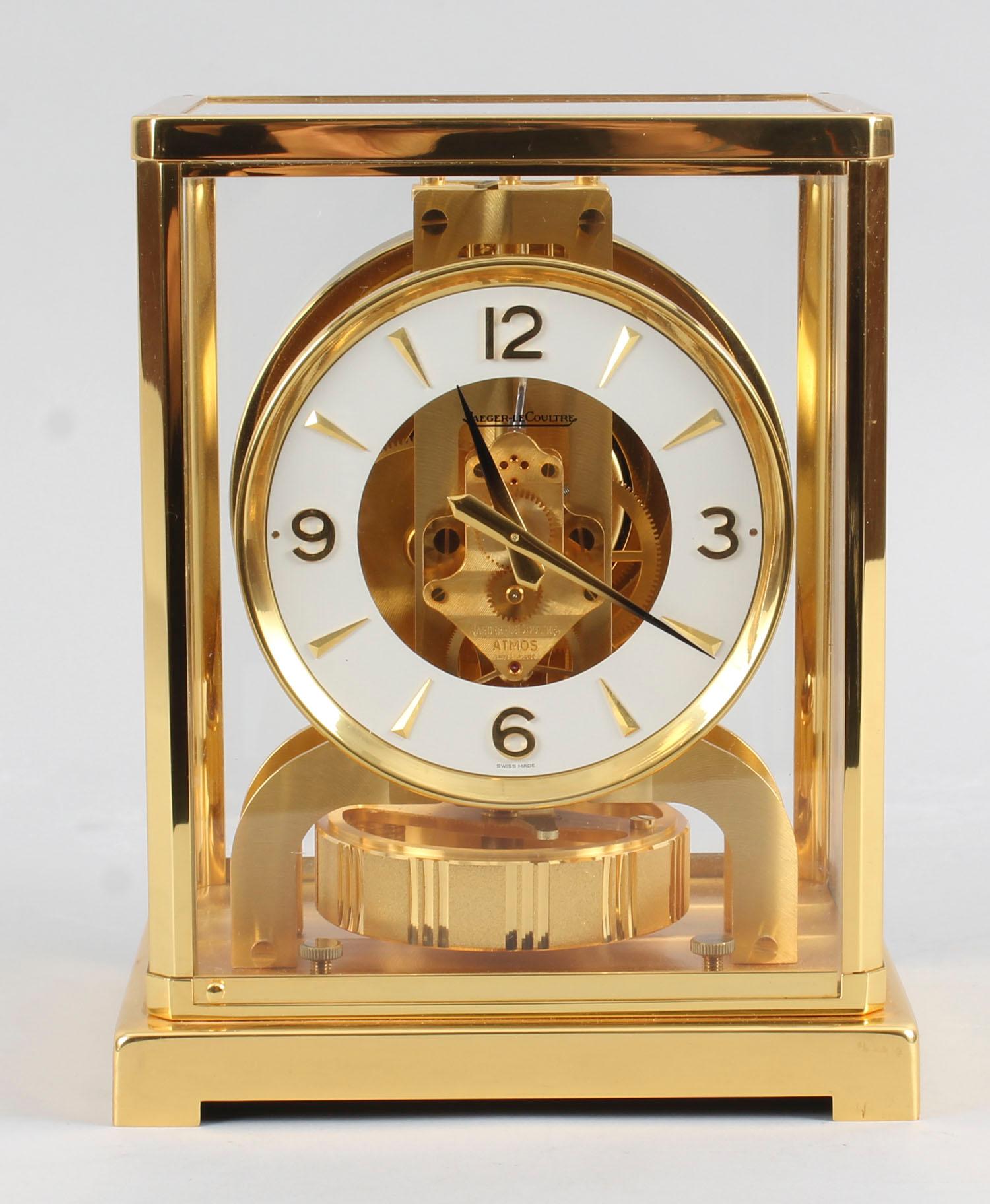 This is beautiful and very decorative Vintage Atmos mantle clock by Jaeger-LeCoultre, bearing their ref No. 491344.

The clock is displayed in a polished gilt rectangular brass case with a glazed door, the case lifts off to allow access to the