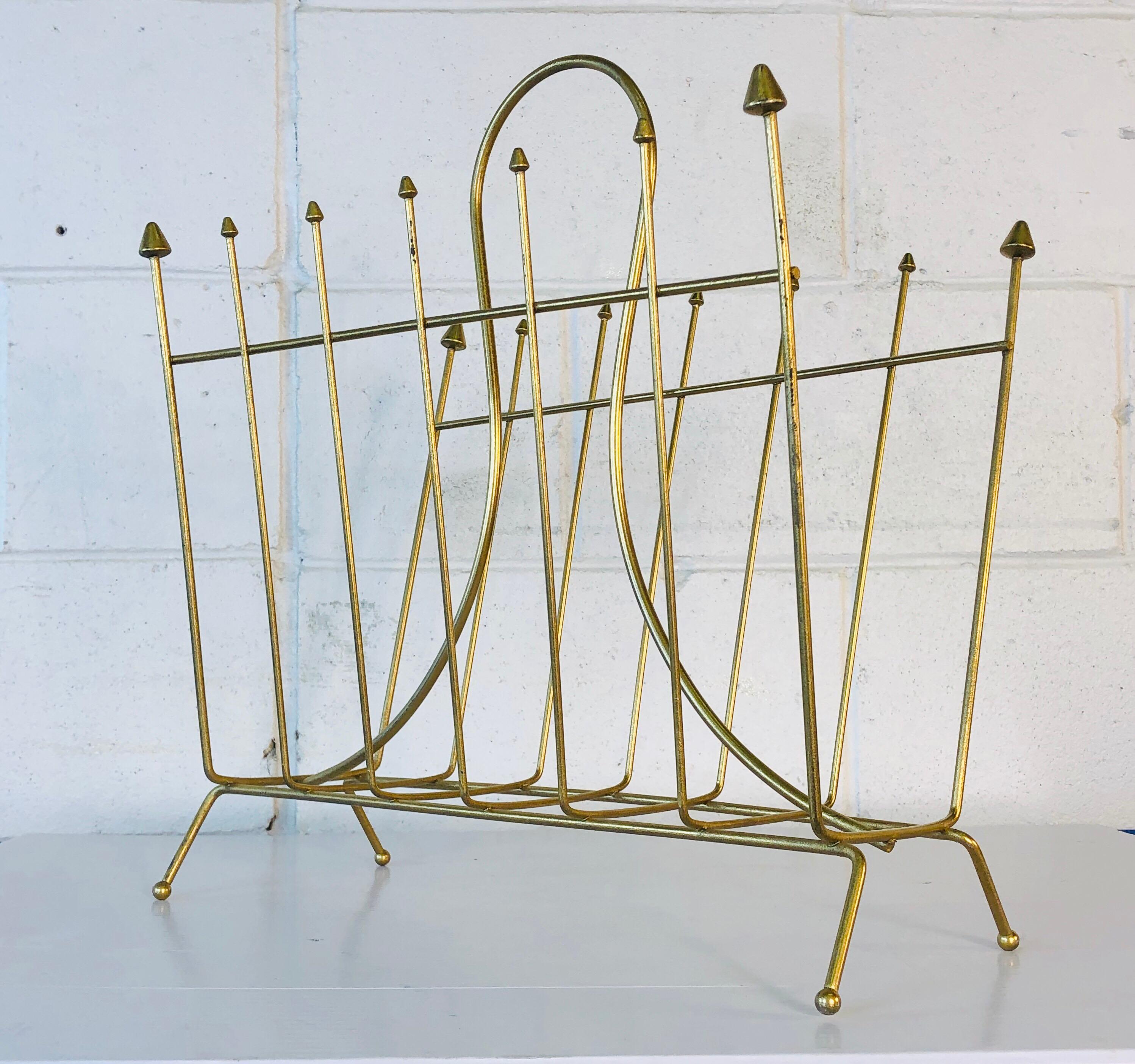 Vintage 1960s Atomic style gold metal magazine rack with pointed tips. The rack has been restored and refinished and is in excellent condition. No marks.