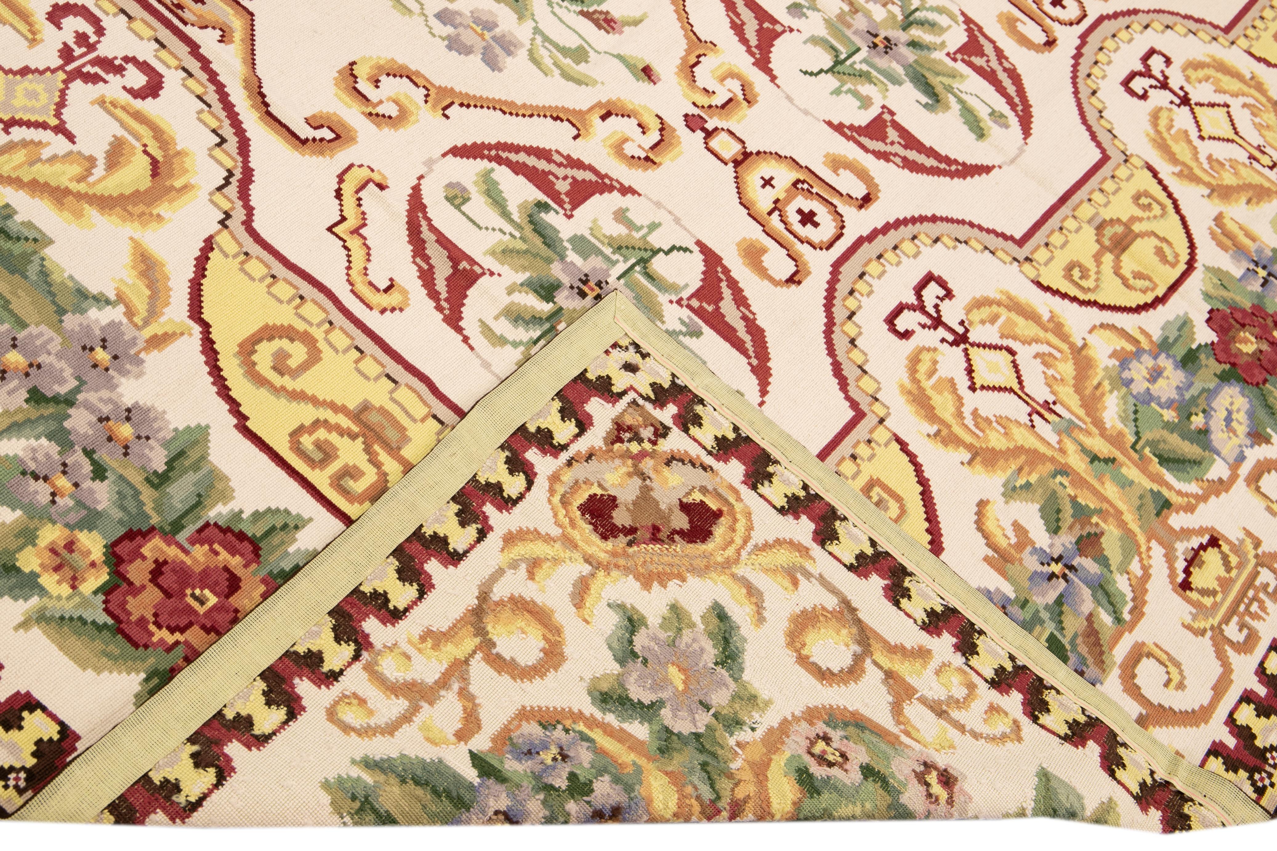 Beautiful Vintage Aubusson Style needlepoint wool rug with an Ivory field. This piece has fine details in a gorgeous multicolor all-over floral pattern design. 

This rug measures 9'1