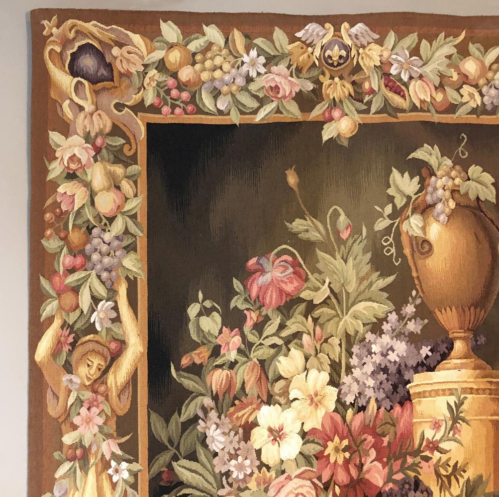 Vintage Aubusson-style tapestry is a celebration of the bounty of the earth, with amazing fruit and floral designs incorporated into the border which surrounds the splendid still life extravaganza at the center of the work. Fair maidens posed as