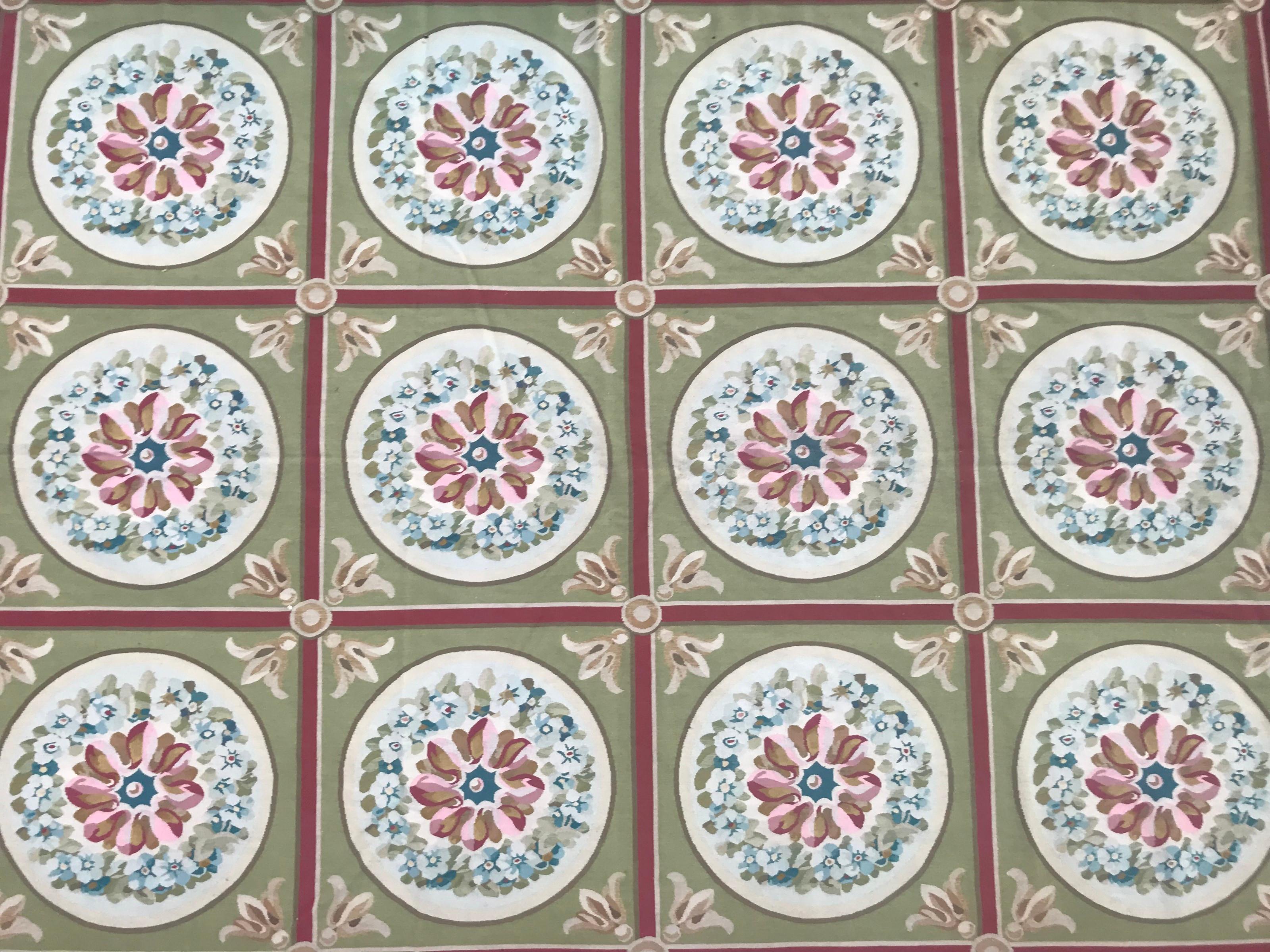 Beautiful handwoven Aubusson design rug with beautiful Louis XVI style design and nice colors with green, pink, yellow and blue, entirely handwoven with wool on cotton foundation.