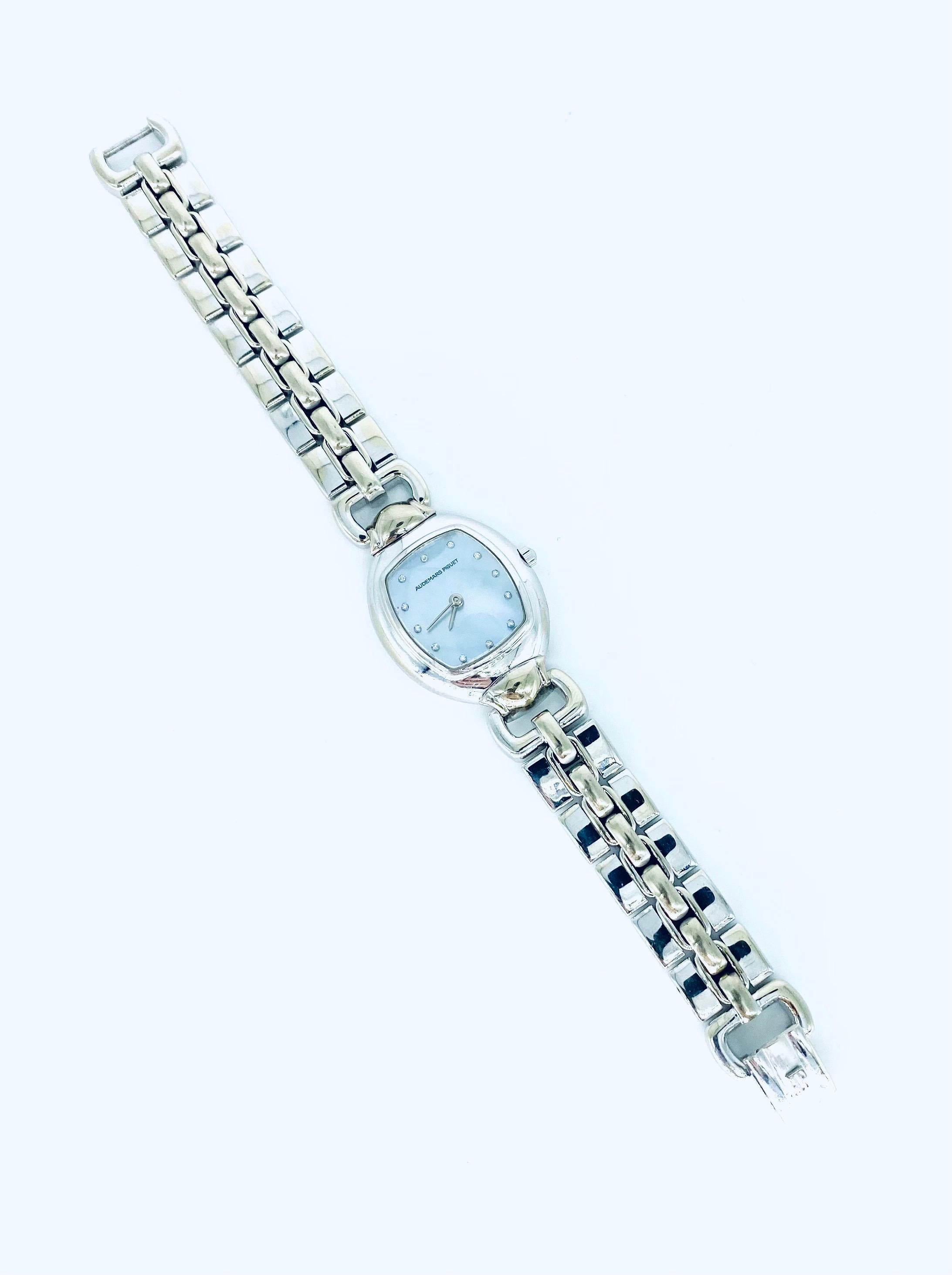 A glamorous and stunning ladies 18k white gold Audemars Piguet wristwatch, with a striking and heavy bracelet, a contemporary cushion-style case, and a gorgeous blue-grey mother-of-pearl dial adorned with 12 diamond hour markers. The case is approx.