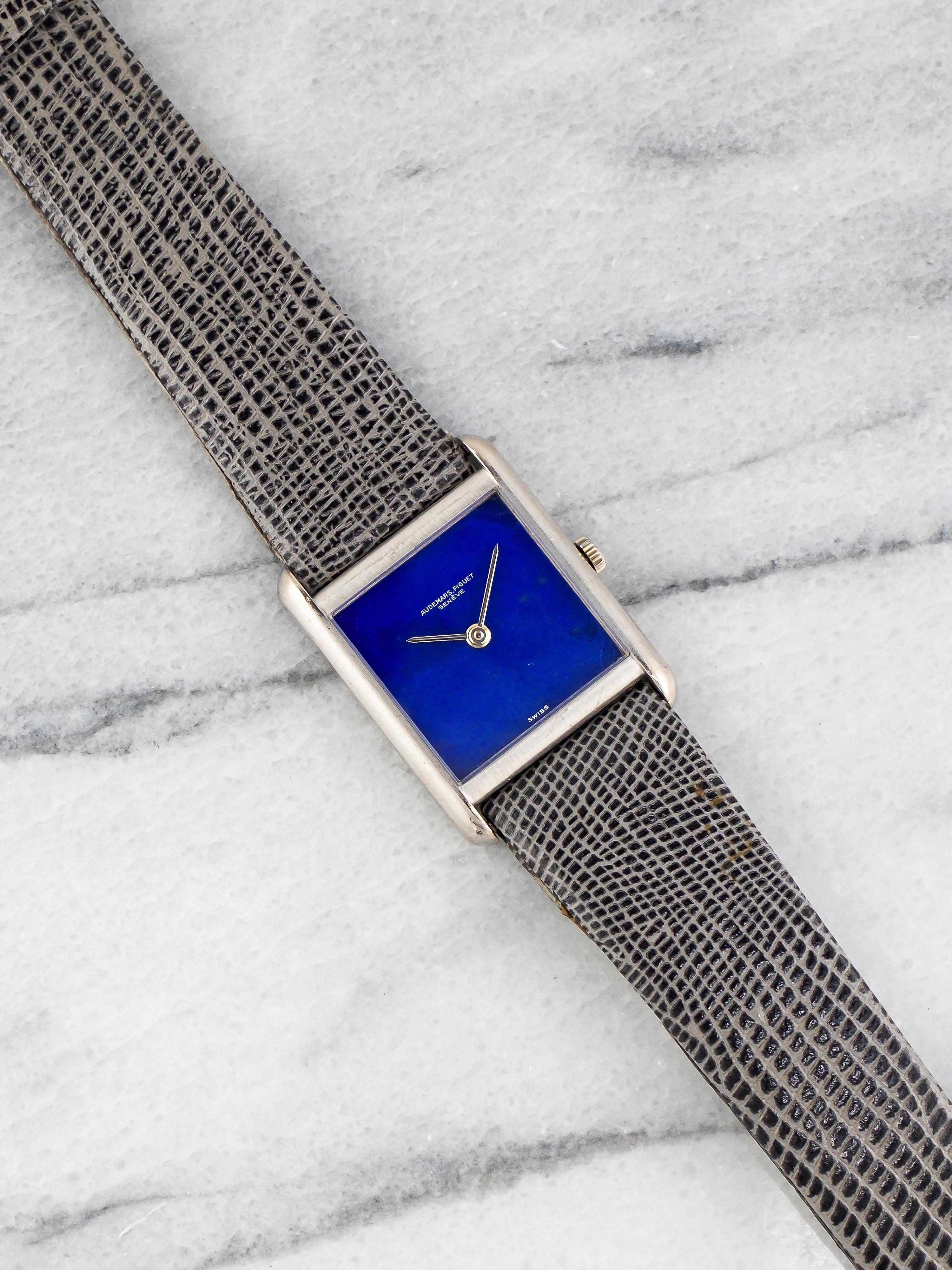 Here's a vintage Audemars Piguet manual wind in 18k white gold with a blue lapis stone dial on a leather strap from the 1970s. Keeps great time and is fully functional. Measurements include a 23x28mm white gold case. It's on a grey leather strap