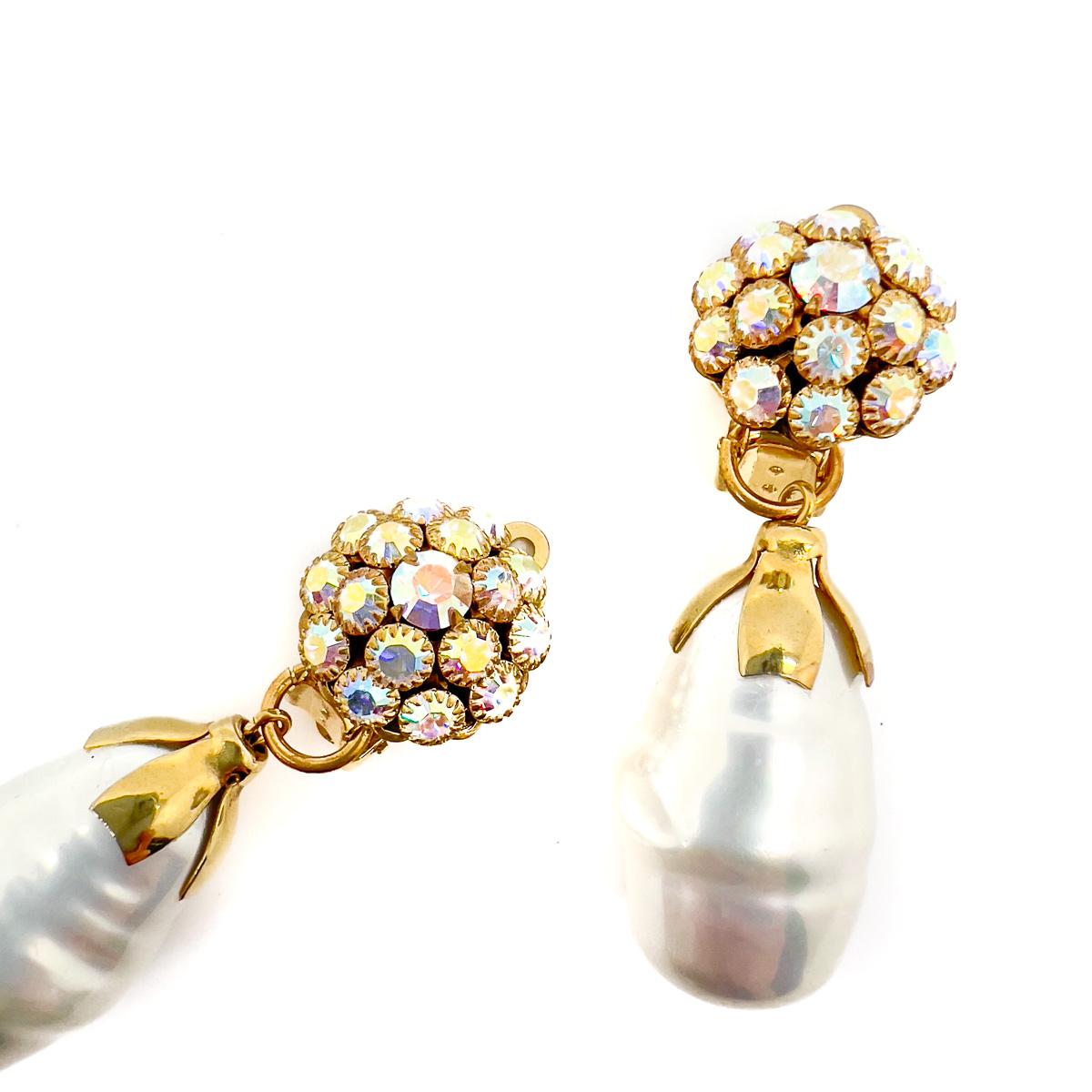 A pair of Vintage Baroque Pearl Drop Earrings. The aurora borealis top proving such a pretty adornment for the ear. Dropping away to a beautiful, extravagant glass baroque pearl suspended from an adorable gold plated pixie cap. Dreamy with an