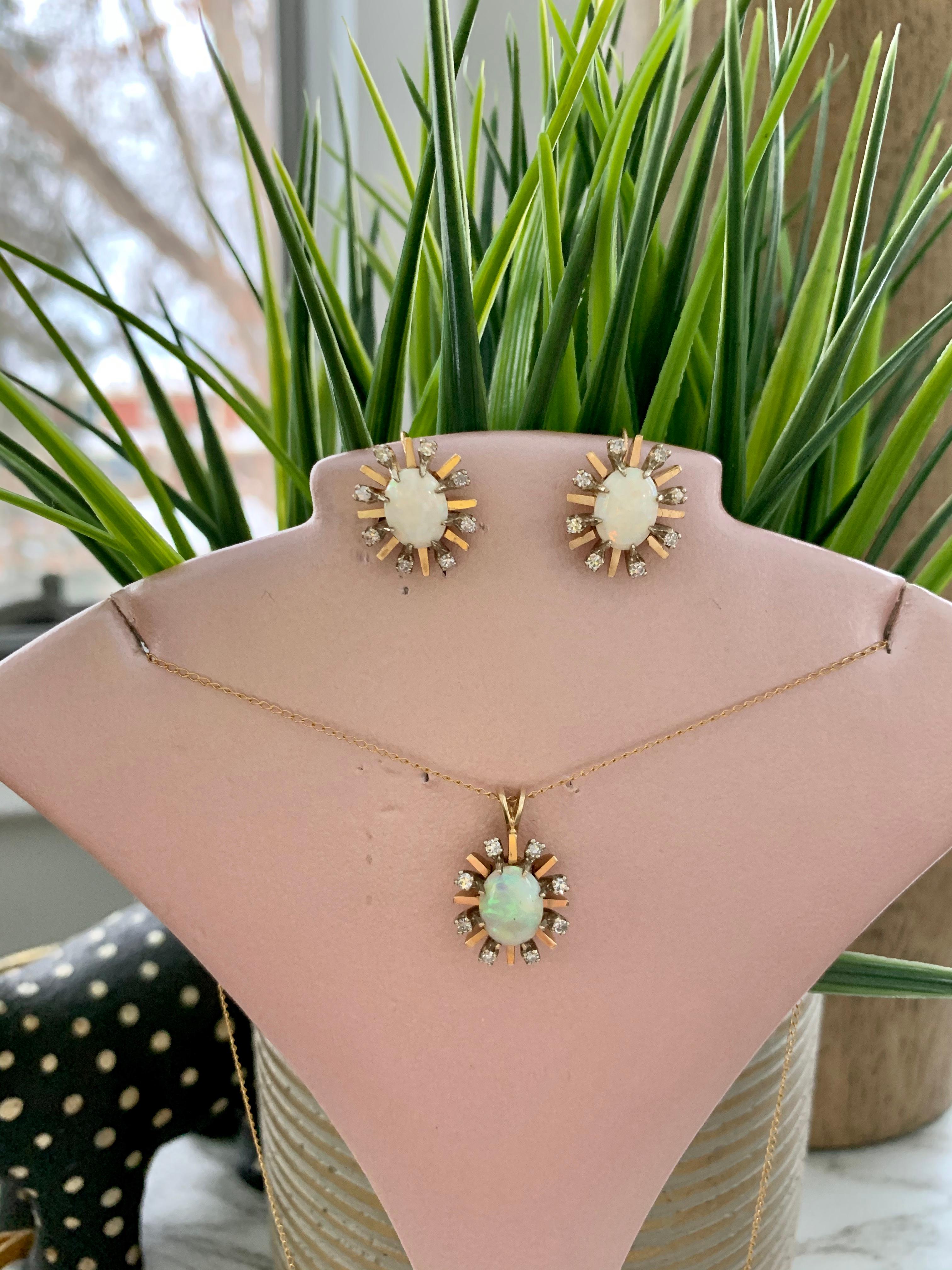 These Opal earrings are quite lovely.  The Australian Opal in each earring has beautiful colors which reflect many colors.  Each Opal is 9x7mm in size and is surrounded by eight 1.7mm single cut Diamonds, all set in 14k yellow Gold.  The Diamonds
