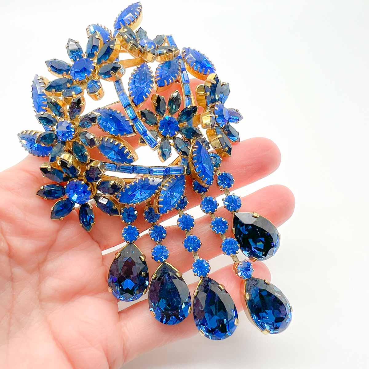 A spectacular work of wearable art. A huge Vintage Fischland Schmuck Statement Brooch. This mid-century Austrian crystal brooch is exquisitely set with a myriad of fancy cut, deep and mid sapphire blue crystals, each individually claw set. The fancy