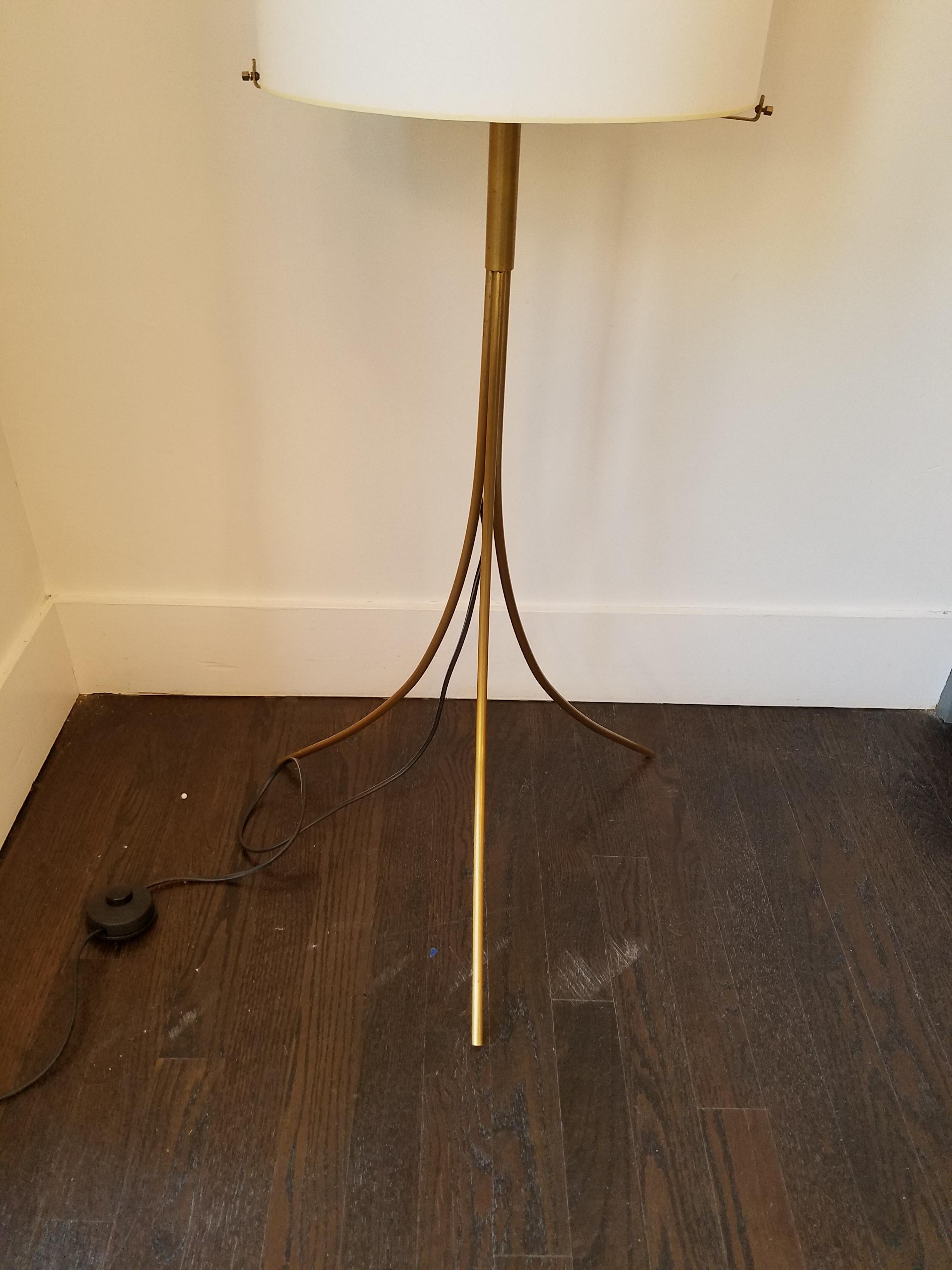 This Kalmar style floor lamp features three brass supporting legs which taper up to support the oval parchment shade (new/custom) with a large ring finial. Made in Austria, circa 1960
New shade is needed.