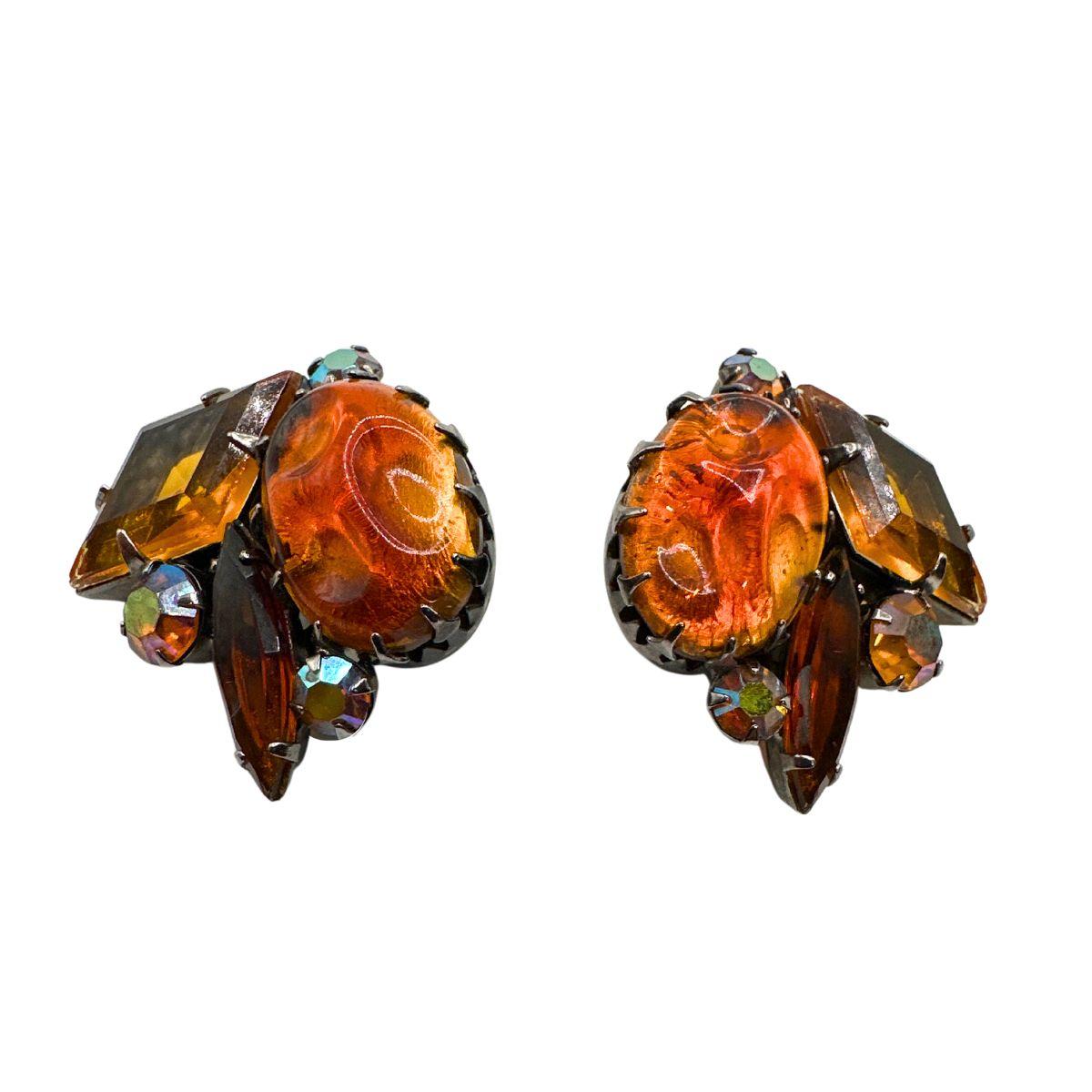Earring Length : 1:22″

Bin Code: E22 / P2

Add a touch of vintage elegance to your ensemble with these stunning Austrian Orange Cut Glass & Rhinestone Earrings. The vibrant orange hue of the glass stones instantly catches the eye and adds a pop of