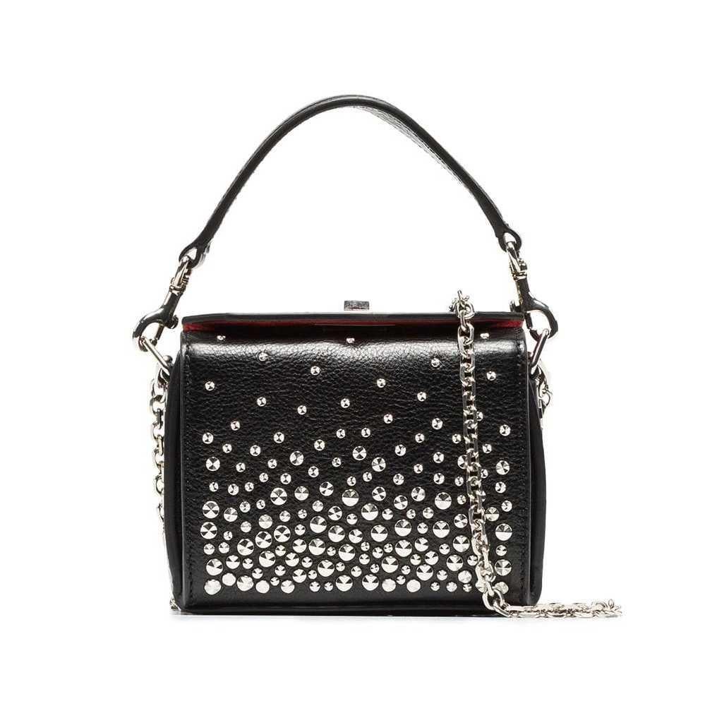This crossbody bag features a studded leather body, a flat leather top handle, a silver-tone chain strap, and a fold-over top with a metal twist lock closure. It carries as AB condition rating.

Inclusions: 
This item does not come with