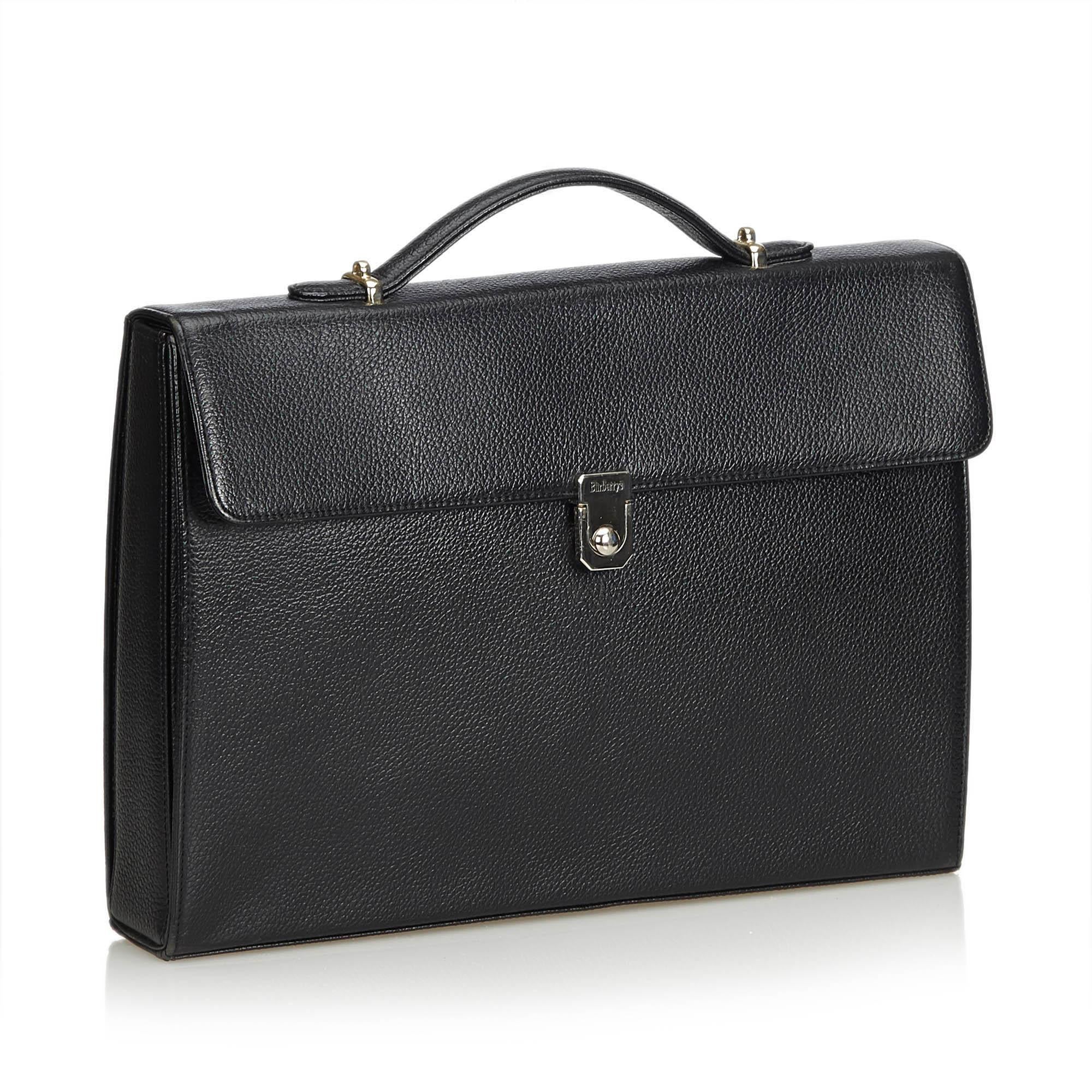 This briefcase features a leather body, flat top handle, flat strap, top flap with push lock closure, exterior slip pocket, and interior zip and slip pockets. It carries as AB condition rating.

Inclusions: 
This item does not come with