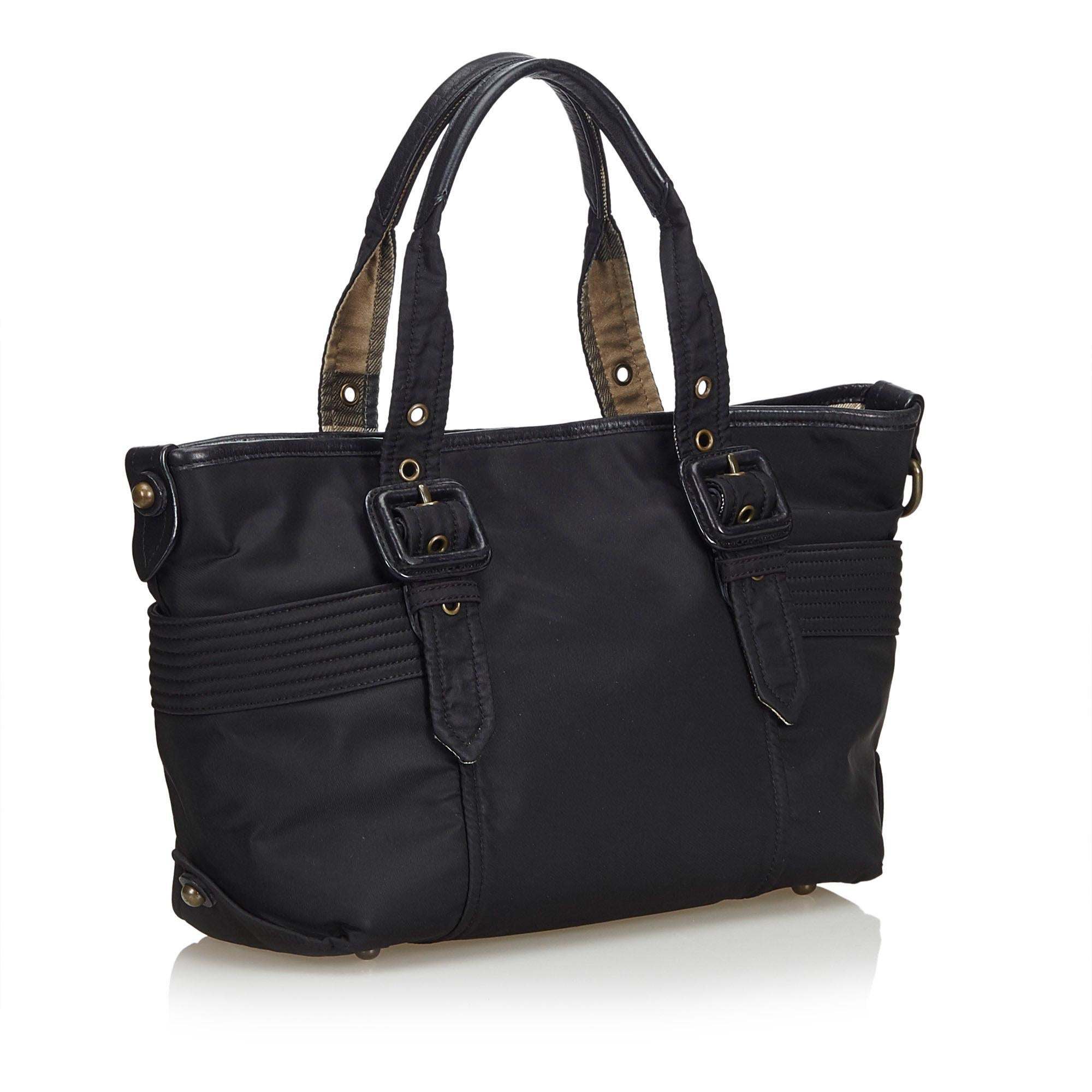 This tote bag features a nylon body, flat leather straps, and an open top with magnetic closure, and interior zip and slip pockets. It carries as AB condition rating.

Inclusions: 
This item does not come with inclusions.

Dimensions:
Length: 21.00