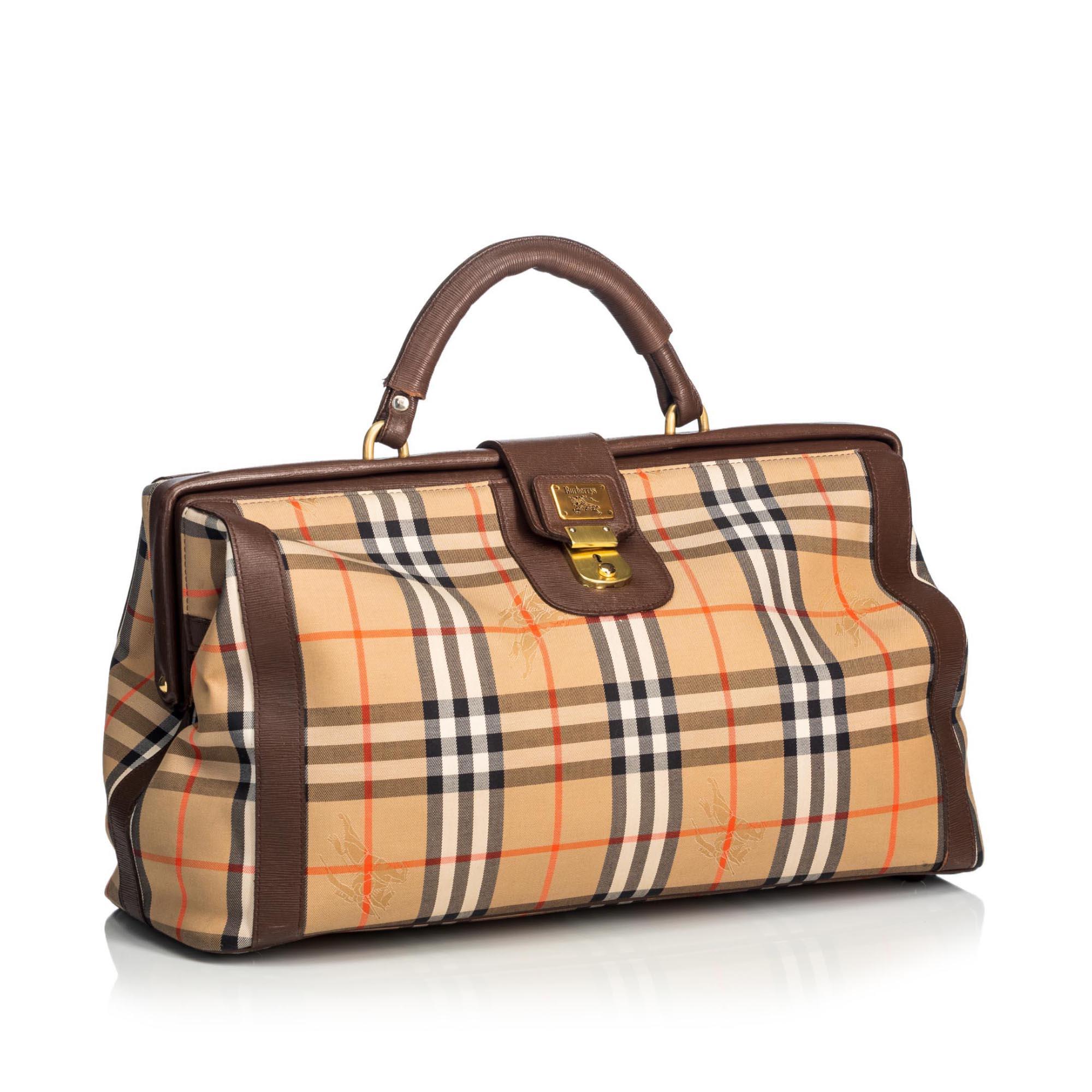This duffle bag features a canvas body with leather trim, rolled leather handles, a top leather lock strap, and a clasp closure. It carries as B+ condition rating.

Inclusions: 
This item does not come with inclusions.

Dimensions:
Length: 25.00