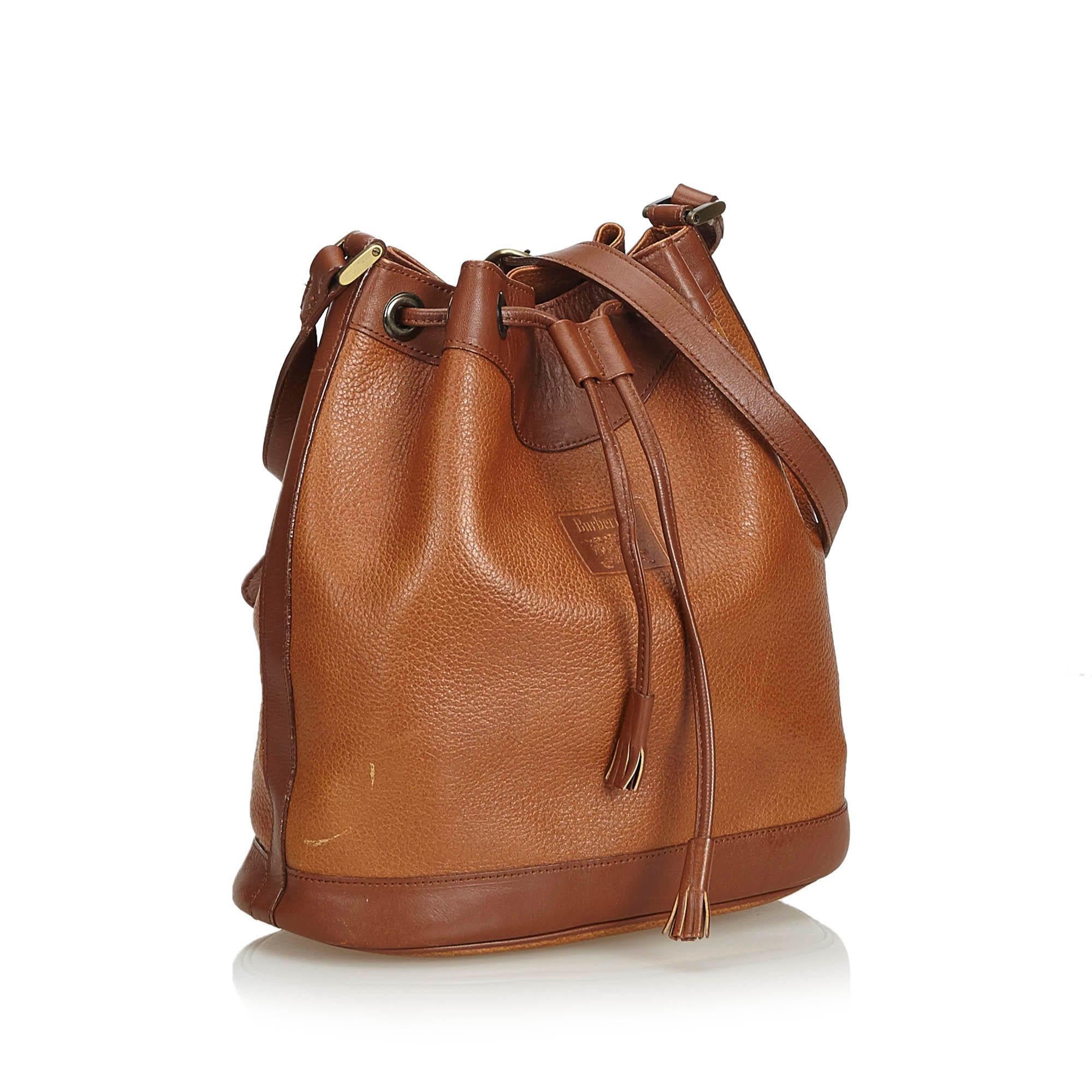 This bucket bag features a leather body, a flat leather strap, a drawstring closure, and interior zip and slip pockets. It carries as B+ condition rating.

Inclusions: 
This item does not come with inclusions.

Dimensions:
Length: 26.00 cm
Width: