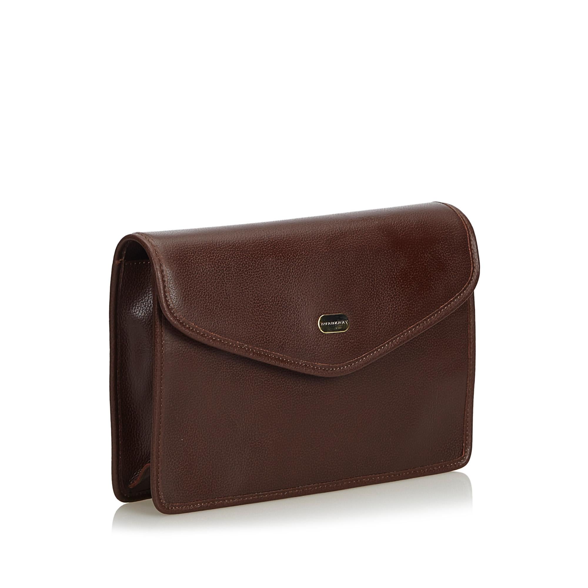 This clutch bag features a leather body, a flat leather hand strap, a front flap with magnetic closure, and an interior zip pocket. It carries as B+ condition rating.

Inclusions: 
This item does not come with inclusions.

Dimensions:
Length: 18.00