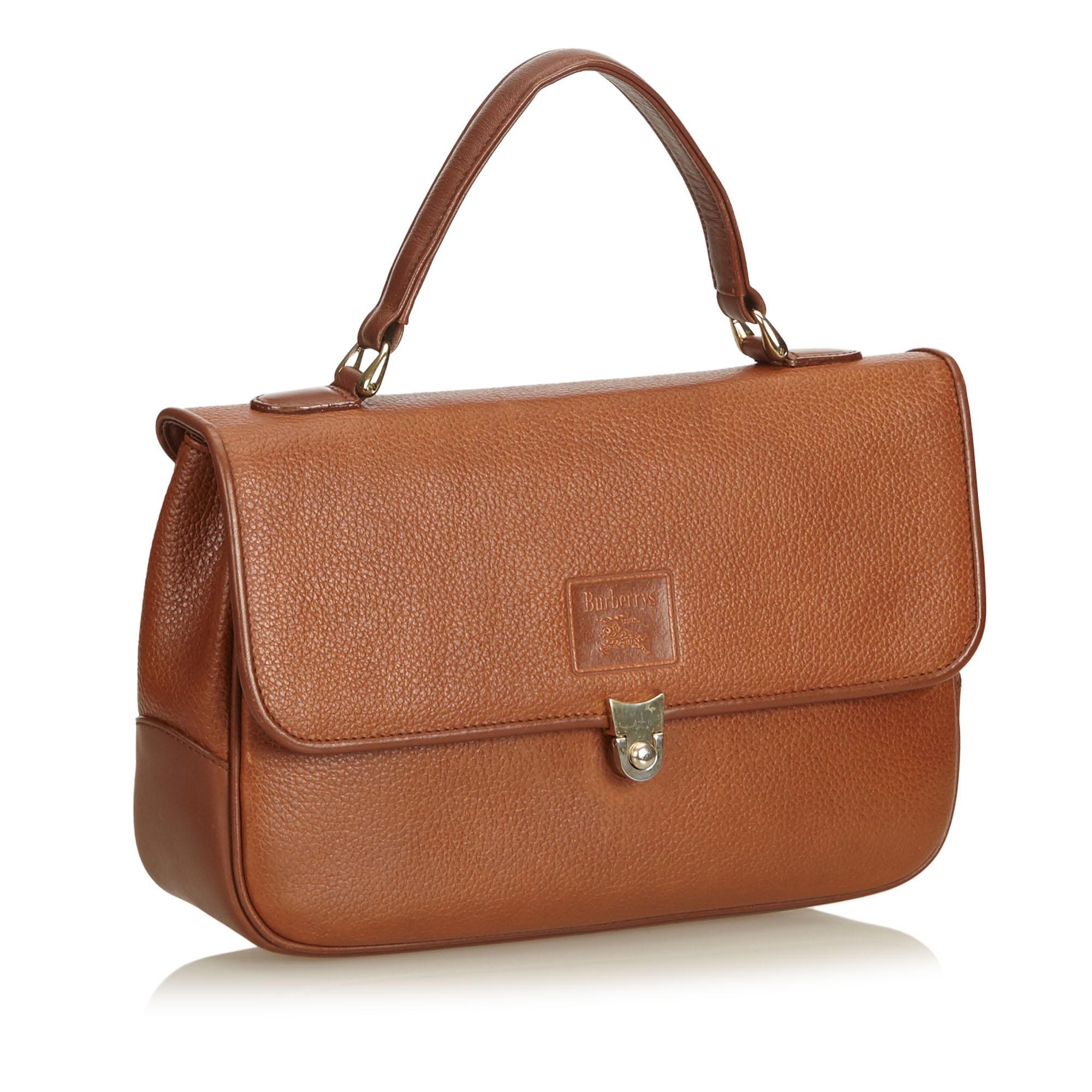 This handbag features a leather body, flat top handle, front flap with push lock closure, exterior zip pocket, and interior zip and slip pockets. It carries as B+ condition rating.

Inclusions: 
This item does not come with