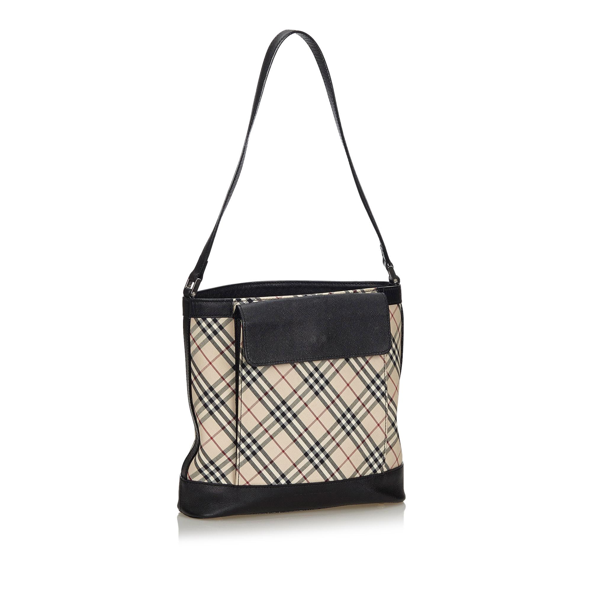 This shoulder bag features a plaid canvas body with leather trim, a front exterior flap pocket, a flat leather strap, a top zip closure, and interior zip and slip pockets. It carries as A condition rating.

Inclusions: 
This item does not come with