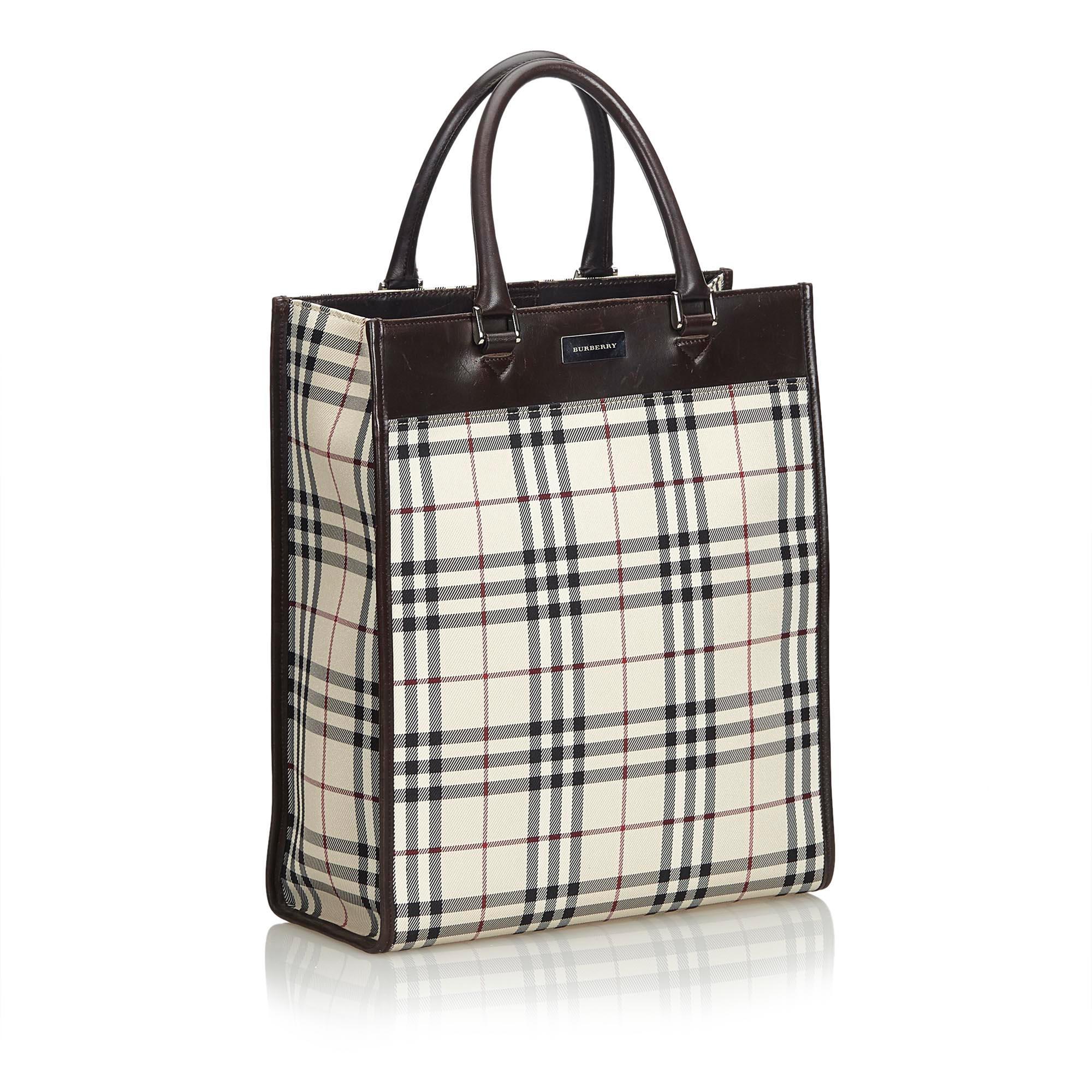 This tote features a plaid nylon body with a top leather panel, rolled leather handles, a top magnetic closure, and an interior zip pocket. It carries as B condition rating.

Inclusions: 
This item does not come with inclusions.

Dimensions:
Length: