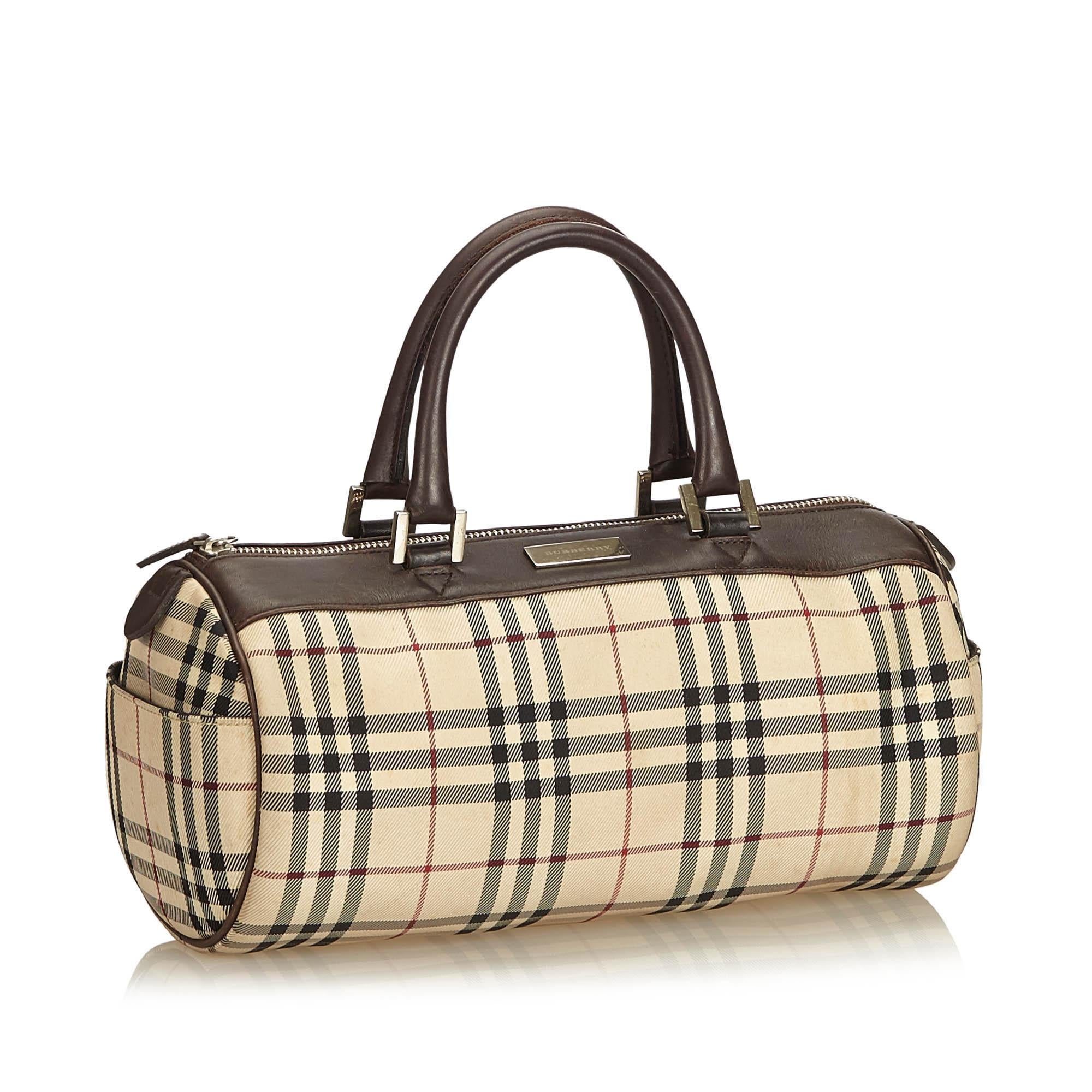 This boston bag features a coated canvas body with leather trim, rolled leather handles, top zip closure, exterior slip pockets and interior slip pocket. It carries as B condition rating.

Inclusions: 
This item does not come with