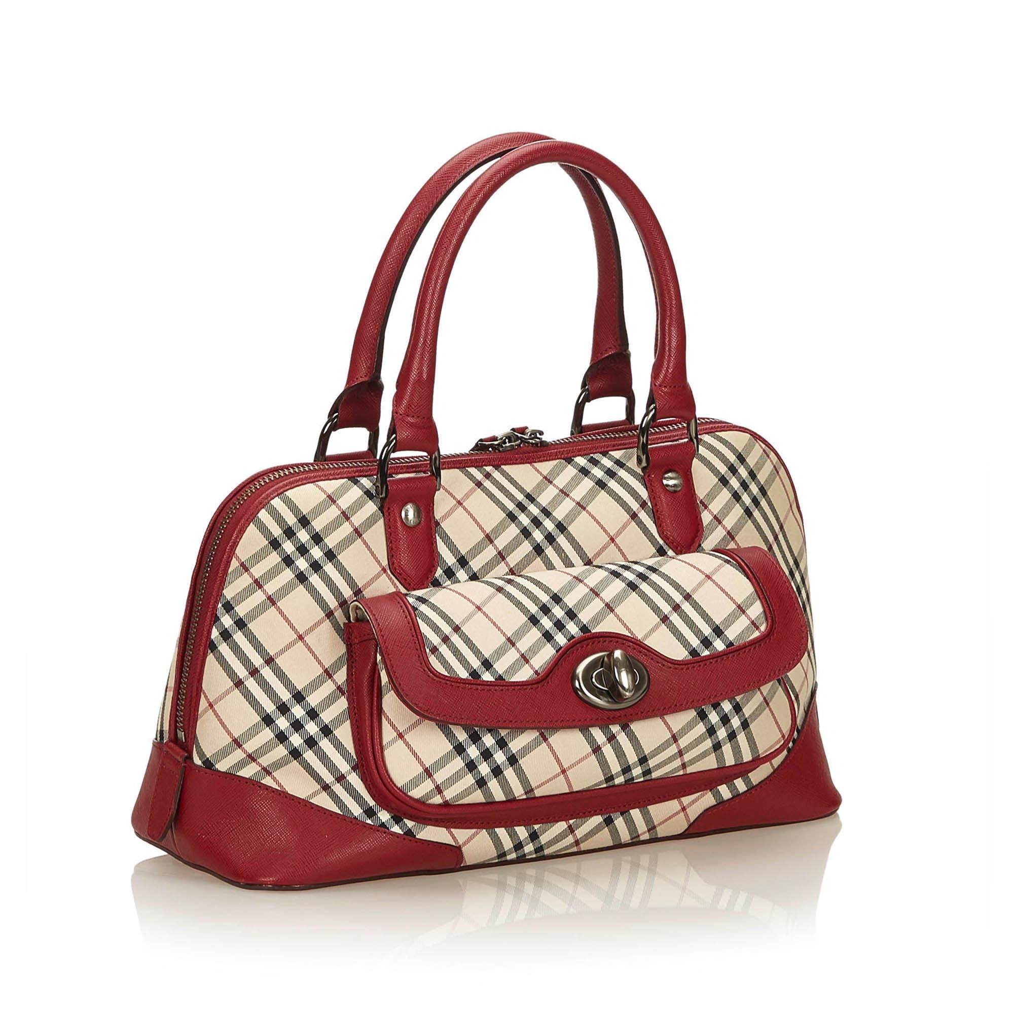 This handbag features a jacquard body, rolled leather handles, top zip closure, exterior flap pocket with twist-lock closure, and interior zip and slip pockets. It carries as A condition rating.

Inclusions: 
This item does not come with