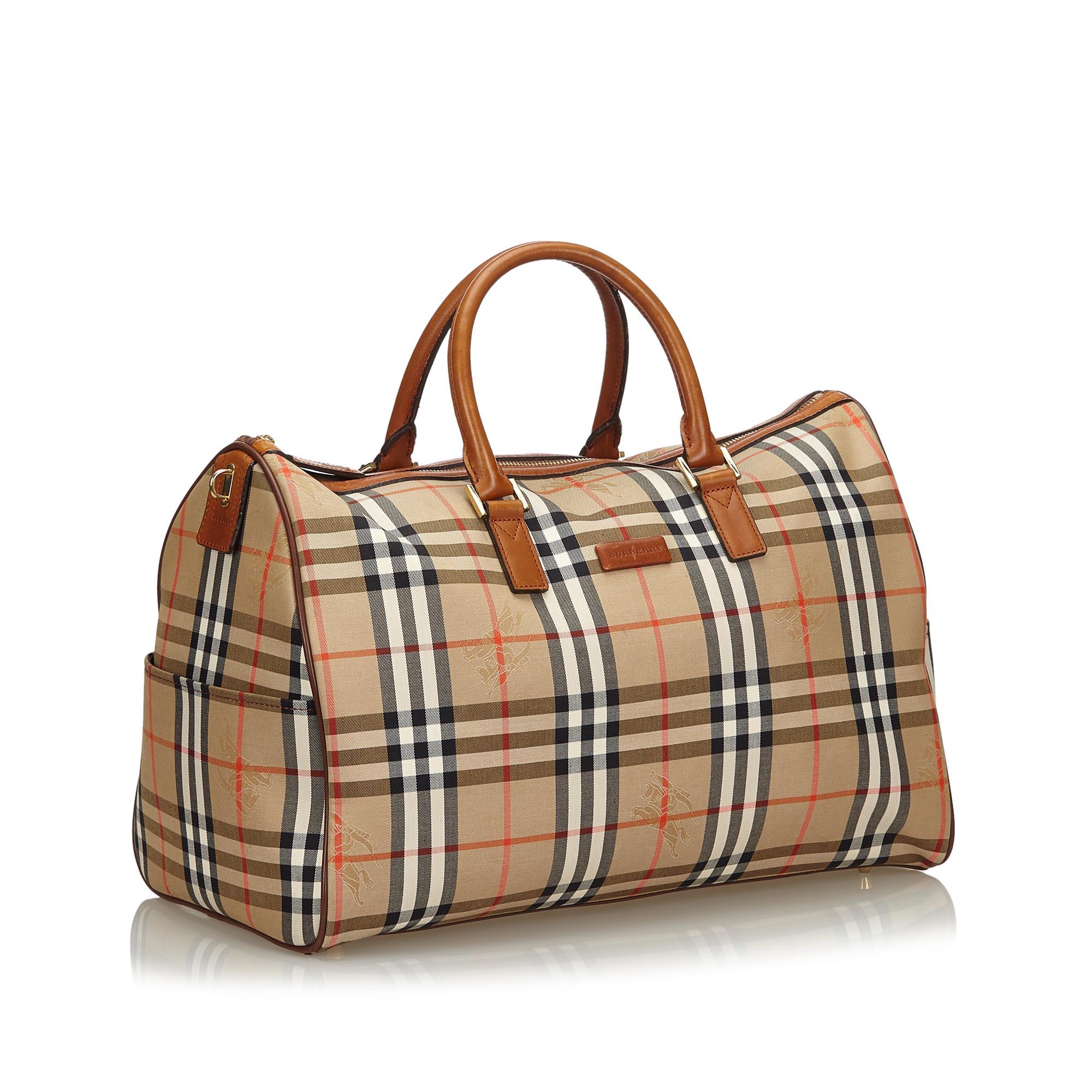 This travel bag features a canvas body with leather trim, exterior side slip pockets, rolled leather handles, a top zip closure, and interior zip and slip pockets. It carries as B+ condition rating.

Inclusions: 
This item does not come with