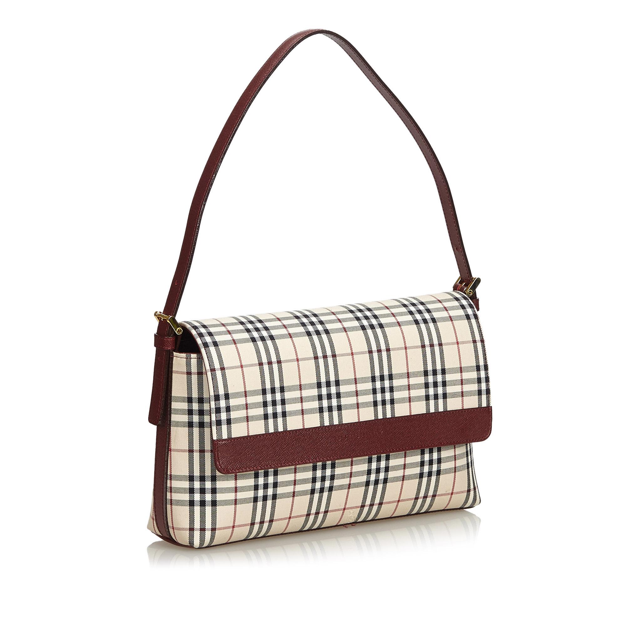 This shoulder bag features a cotton body with leather trim, a back exterior slip pocket, a flat leather strap, a top flap with a magnetic closure, an open top, and interior zip and slip pockets. It carries as AB condition rating.

Inclusions: 
Dust