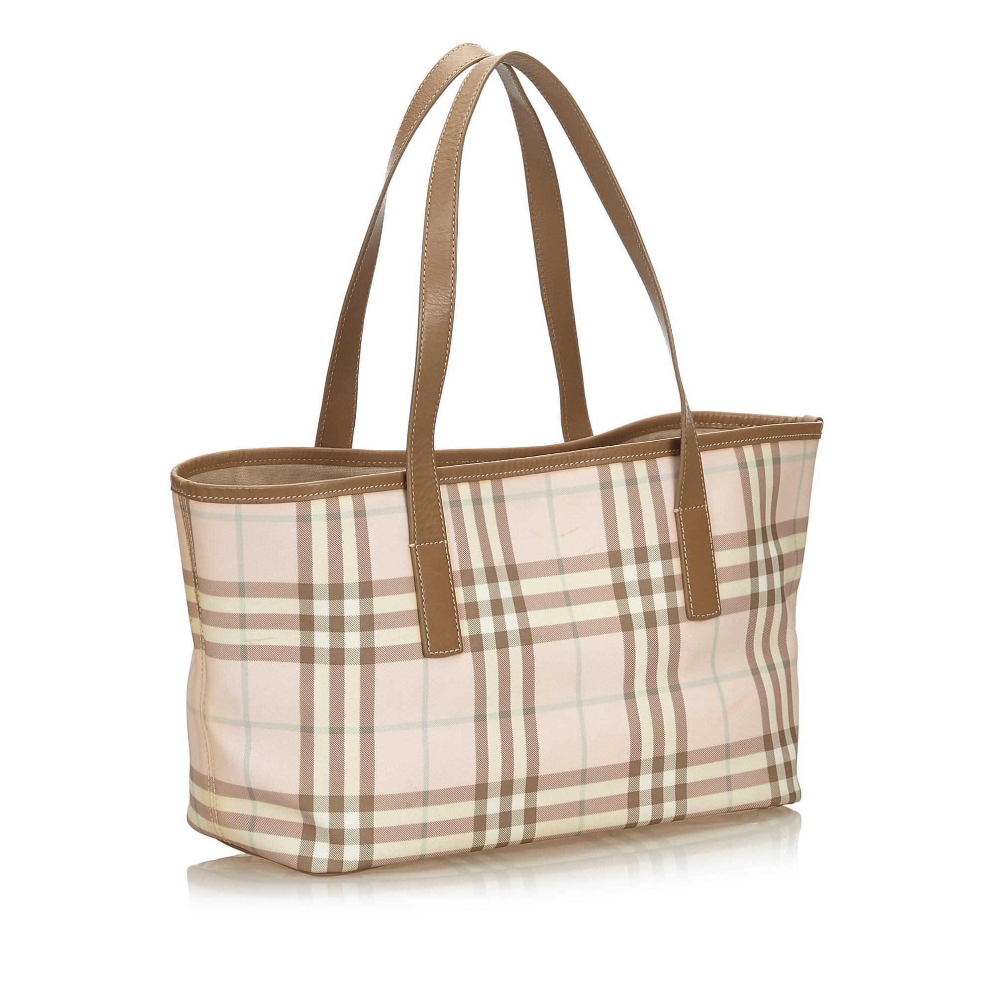 This tote bag features a plaid jacquard body with leather trim, flat leather straps, open top with magnetic snap button closure, and interior zip and slip pockets. It carries as B+ condition rating.

Inclusions: 
This item does not come with