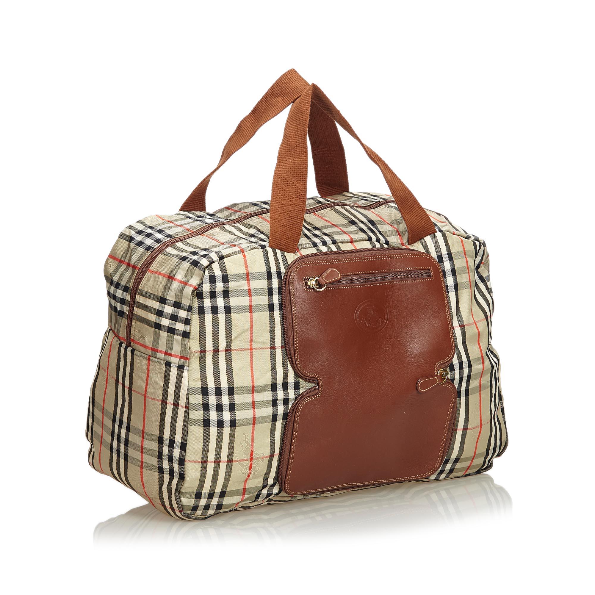 This duffle bag features a nylon body with leather trim, front exterior zip pockets, flat top handles, and a top zip closure. It carries as B+ condition rating.

Inclusions: 
This item does not come with inclusions.

Dimensions:
Length: 29.00