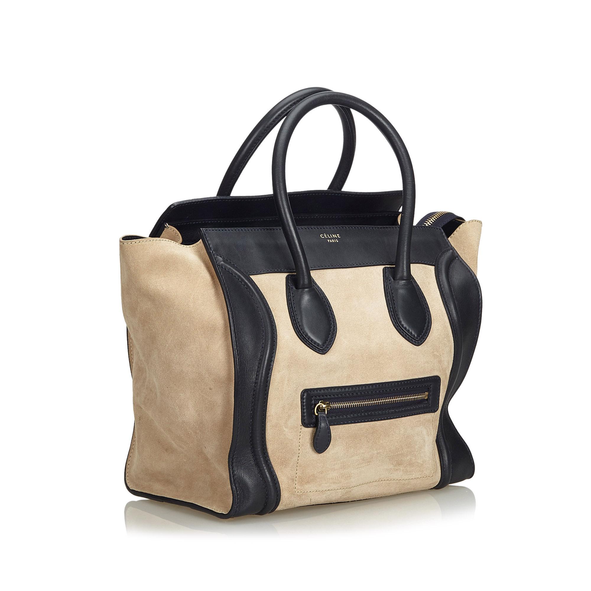 The Phantom tote bag features a leather body, a front exterior zip pocket, rolled leather handles, an open top, and interior zip pocket. It carries as B+ condition rating.

Inclusions: 
This item does not come with inclusions.

Dimensions:
Length: