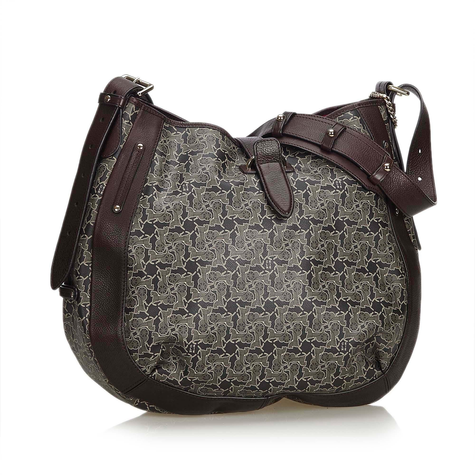 This shoulder bag features a PVC body with leather trim, flat leather shoulder strap, an open top with a flat strap and belt closure, and interior zip and slip pockets. It carries as AB condition rating.

Inclusions: 
Dust Bag
Dimensions:
Length: