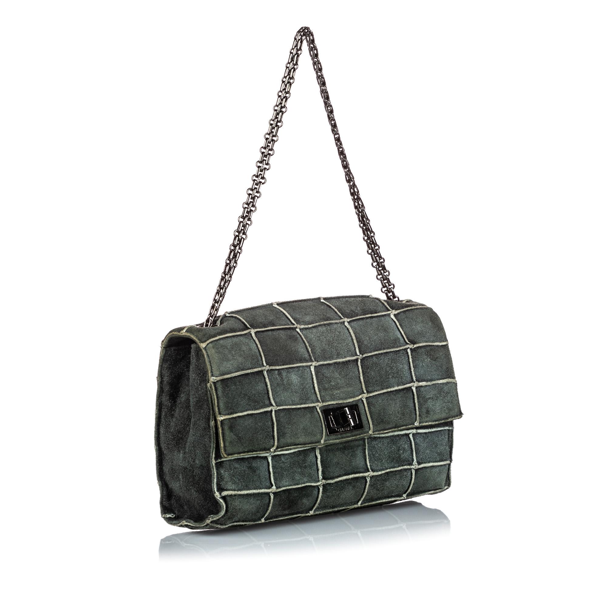 The Reissue Patchwork Flap shoulder bag features a suede patchwork body, a silver-tone chain strap, a front flap with the reissue twist lock closure, and an interior zip pocket. It carries as B+ condition rating.

Inclusions: 
Authenticity