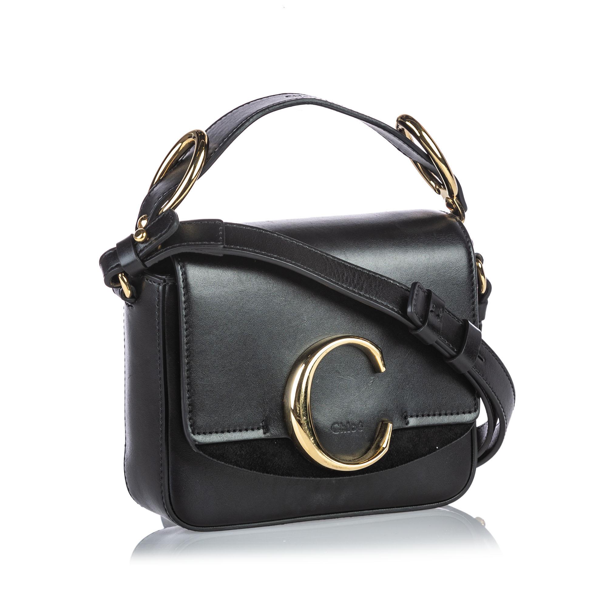 The Mini C crossbody bag features a leather body, flat leather strap, flat top handle, top flap with magnetic closure, and an interior slip pocket. It carries as B+ condition rating.

Inclusions: 
This item does not come with