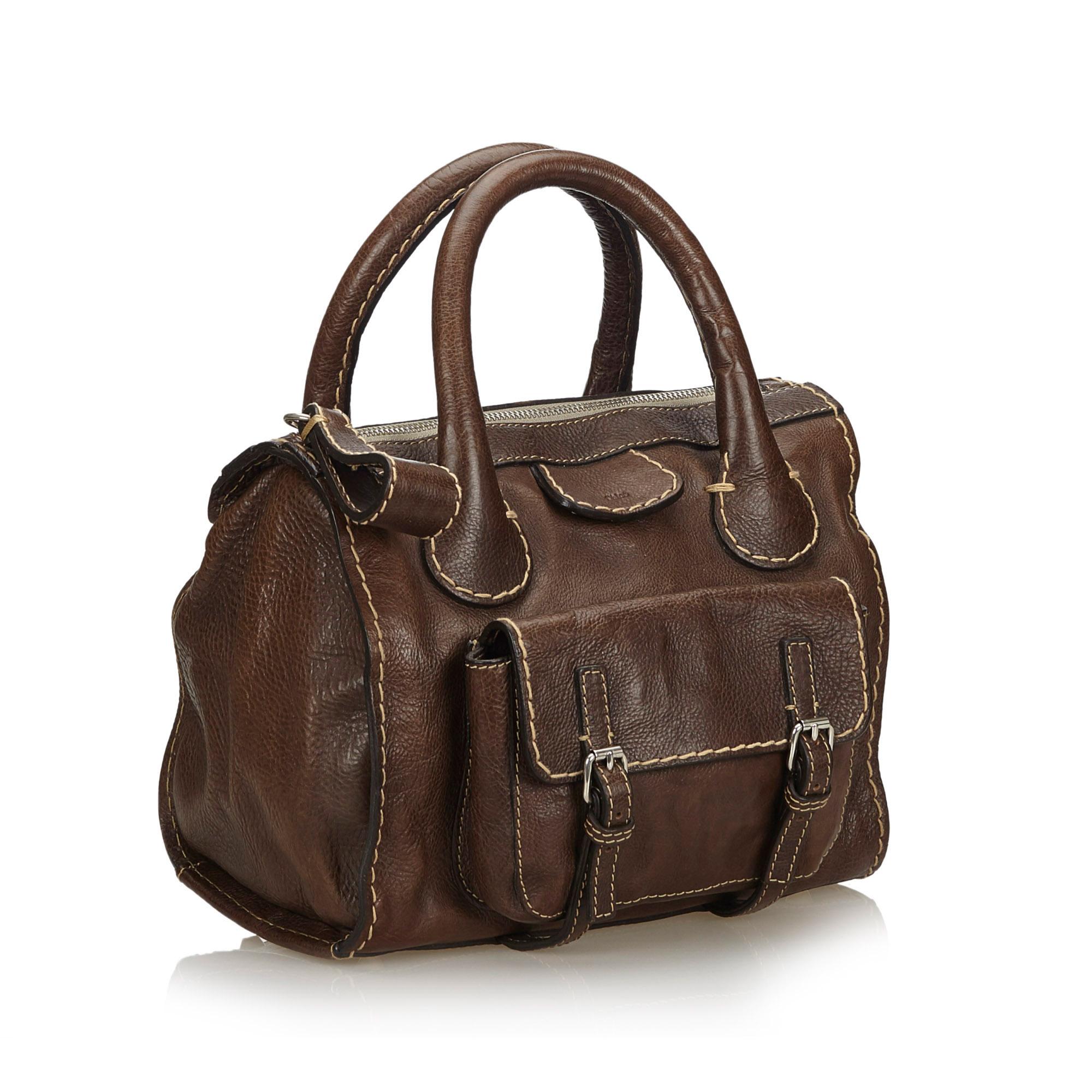 The Edith handbag features a leather body, a front exterior flap pocket, rolled leather handles, a top zip closure, and an interior zip pocket. It carries as B+ condition rating.

Inclusions: 
This item does not come with