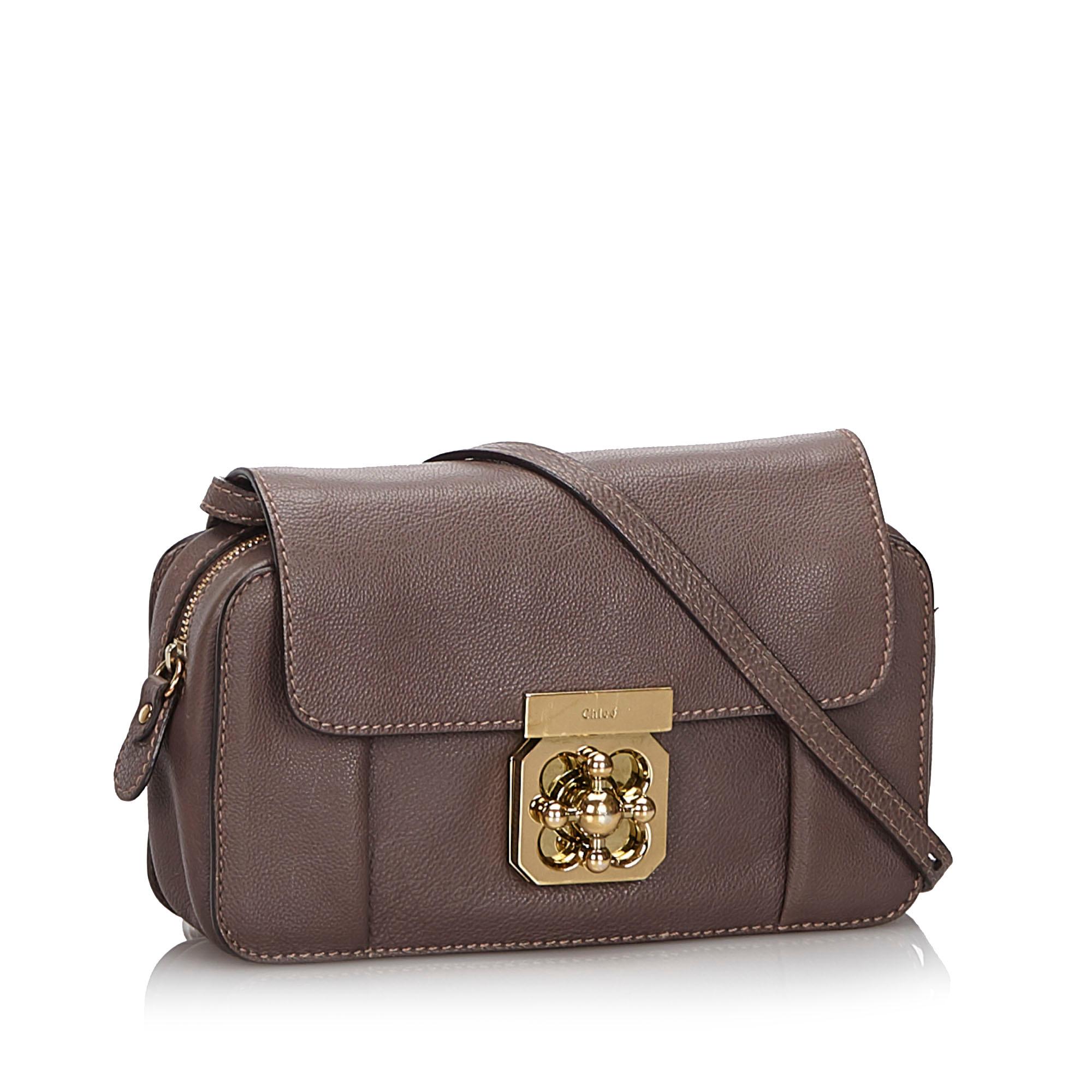 The Mini Elsie crossbody bag features a leather body, a flat leather strap, a front flap with a lock closure, a top zip closure, and interior slip pockets. It carries as B+ condition rating.

Inclusions: 
This item does not come with