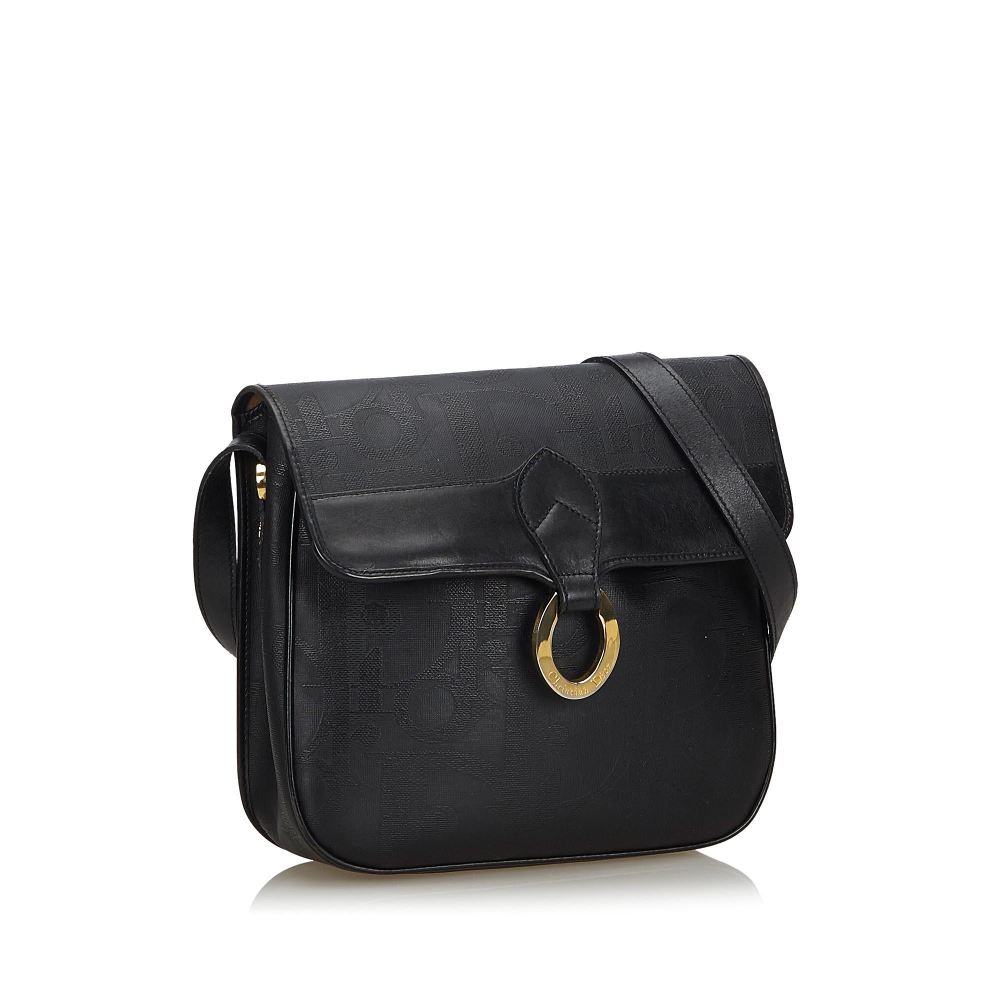 This crossbody bag features a PVC body with leather trim, a flat leather strap, a front flap with a magnetic closure, and an interior zip pocket. It carries as B+ condition rating.

Inclusions: 
This item does not come with