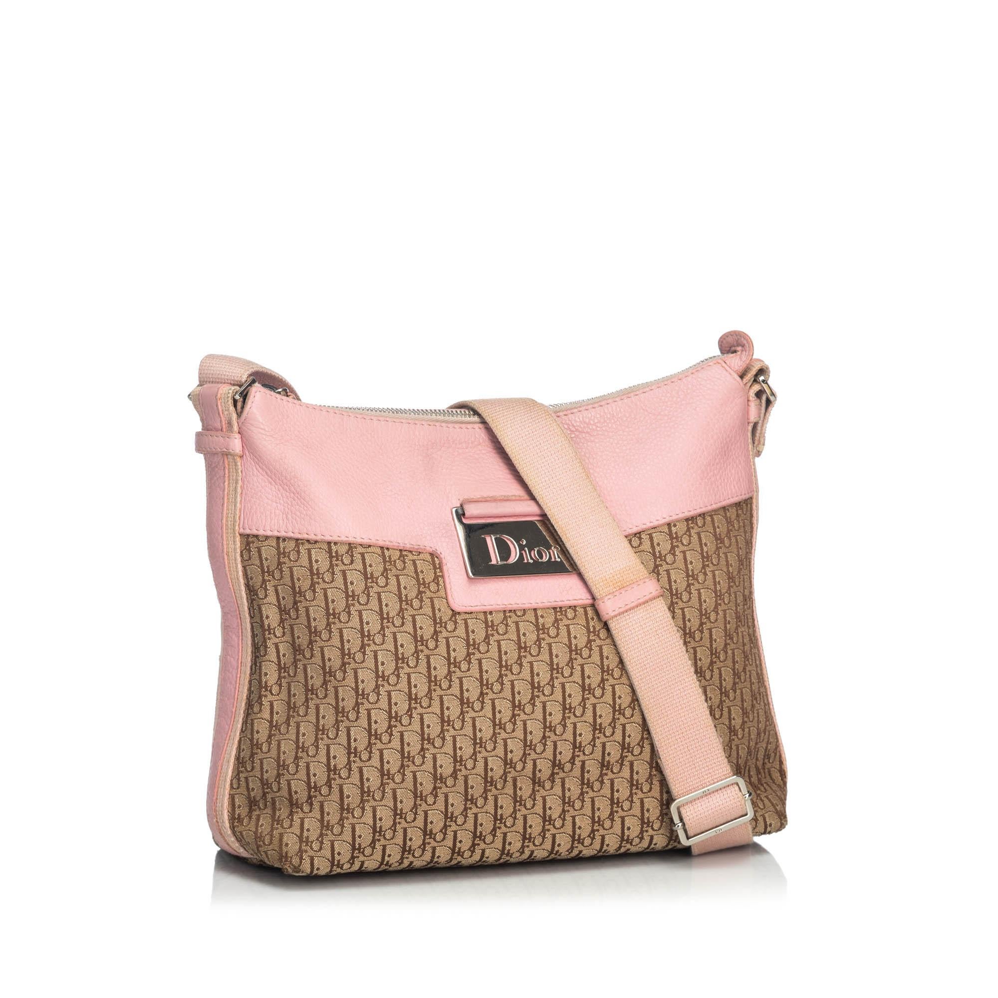 This crossbody bag features a canvas body with leather trim, a flat nylon strap, a top zip closure, and an interior zip pocket. It carries as B+ condition rating.

Inclusions: 
This item does not come with inclusions.

Dimensions:
Length: 22.00